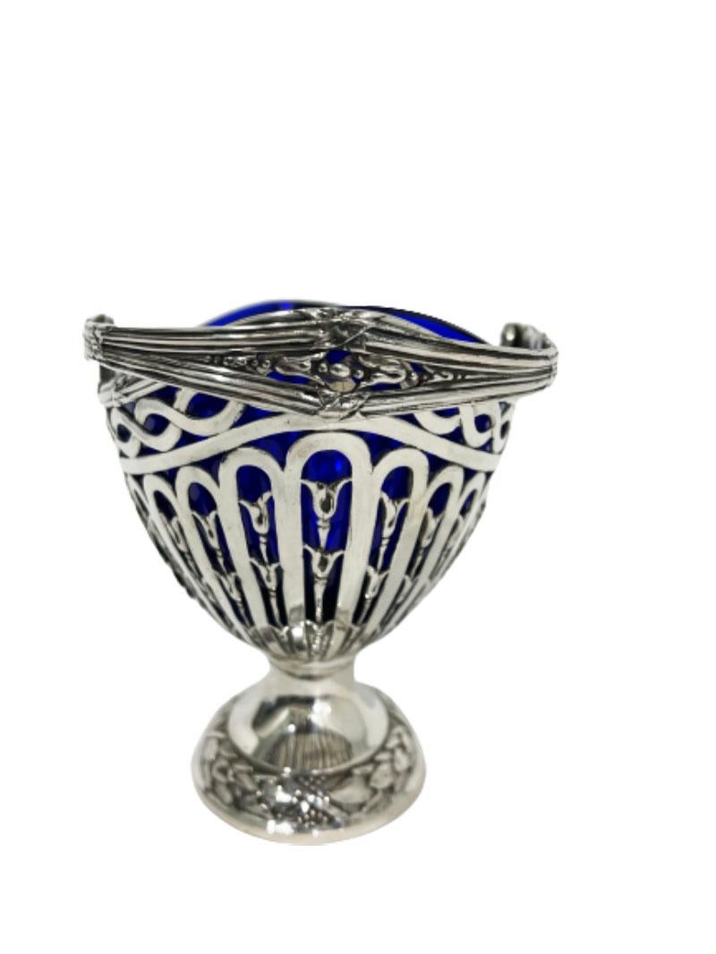 German silver basket with blue glass by Storck & Sinsheimer

An early 20th Century silver 800/1000 basket with movable handle and blue glass.
Marked by Jacob Storck & Louis Sinsheimer, Hanau, Germany
Storch & Sinsheimer is a German manufacturer