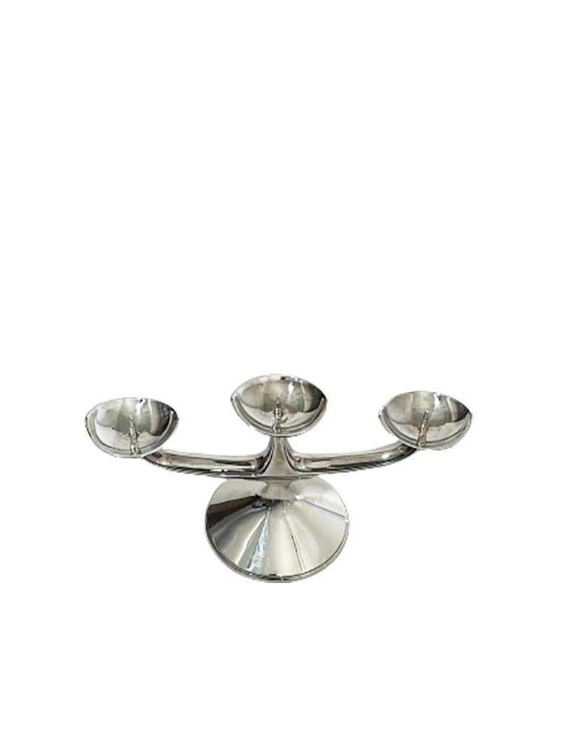 German silver candlestick by Wilhelm T. Binder

3 Arm silver candlestick. The candlestick is hollow silver and has a weighted base.
The candlestick has German silver hall marks of the crescent, Crown, Master Sign of WTB (Wilhem T. Binder)

The