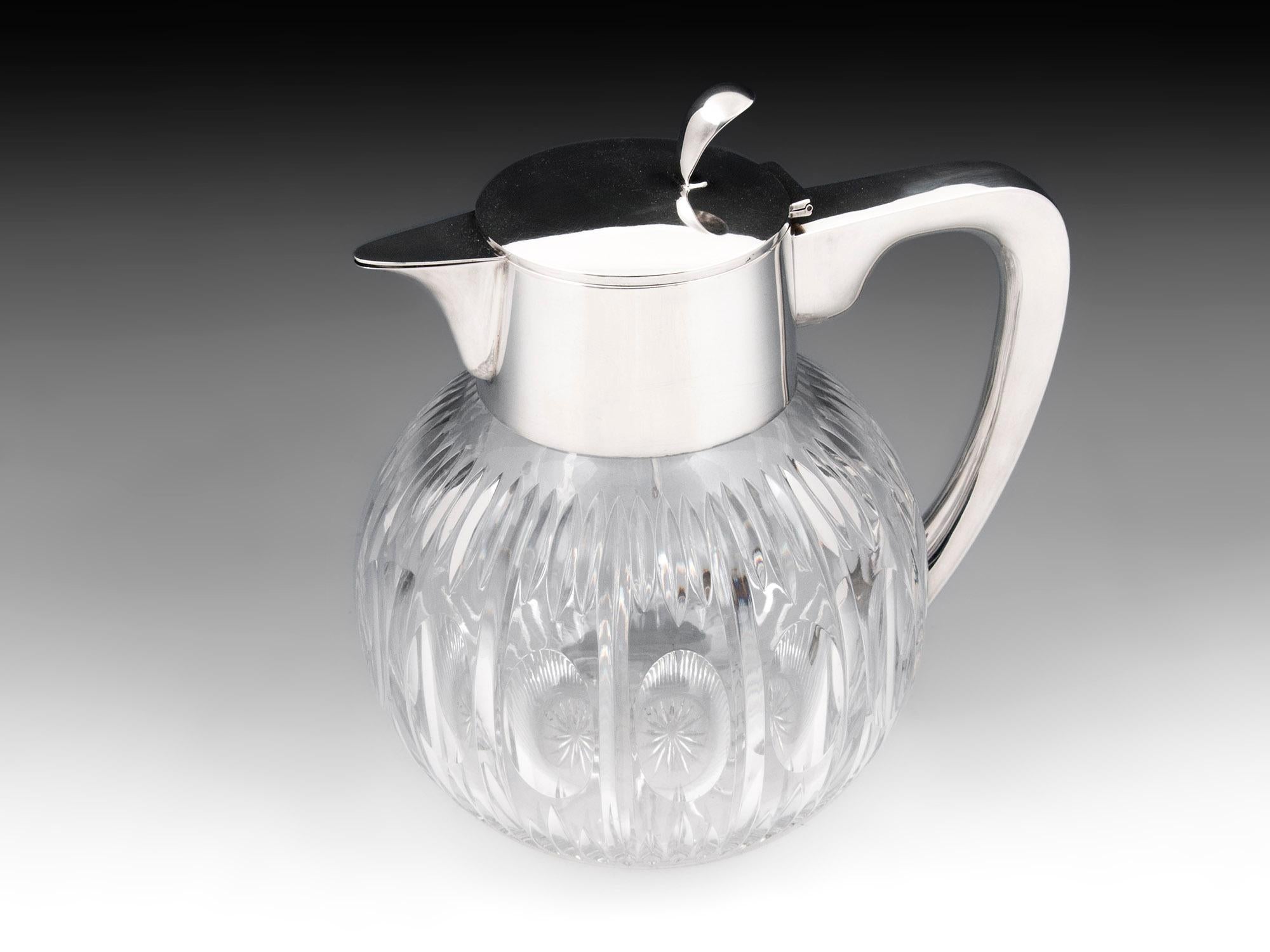Mid-Century Modern Circa 1960

From our Decanter collection, we are pleased to offer this German Silver Mounted Glass Pitcher. The Glass picture of globular form with large rounded hand-cut glass body, star cut base and decorated body mounted with a