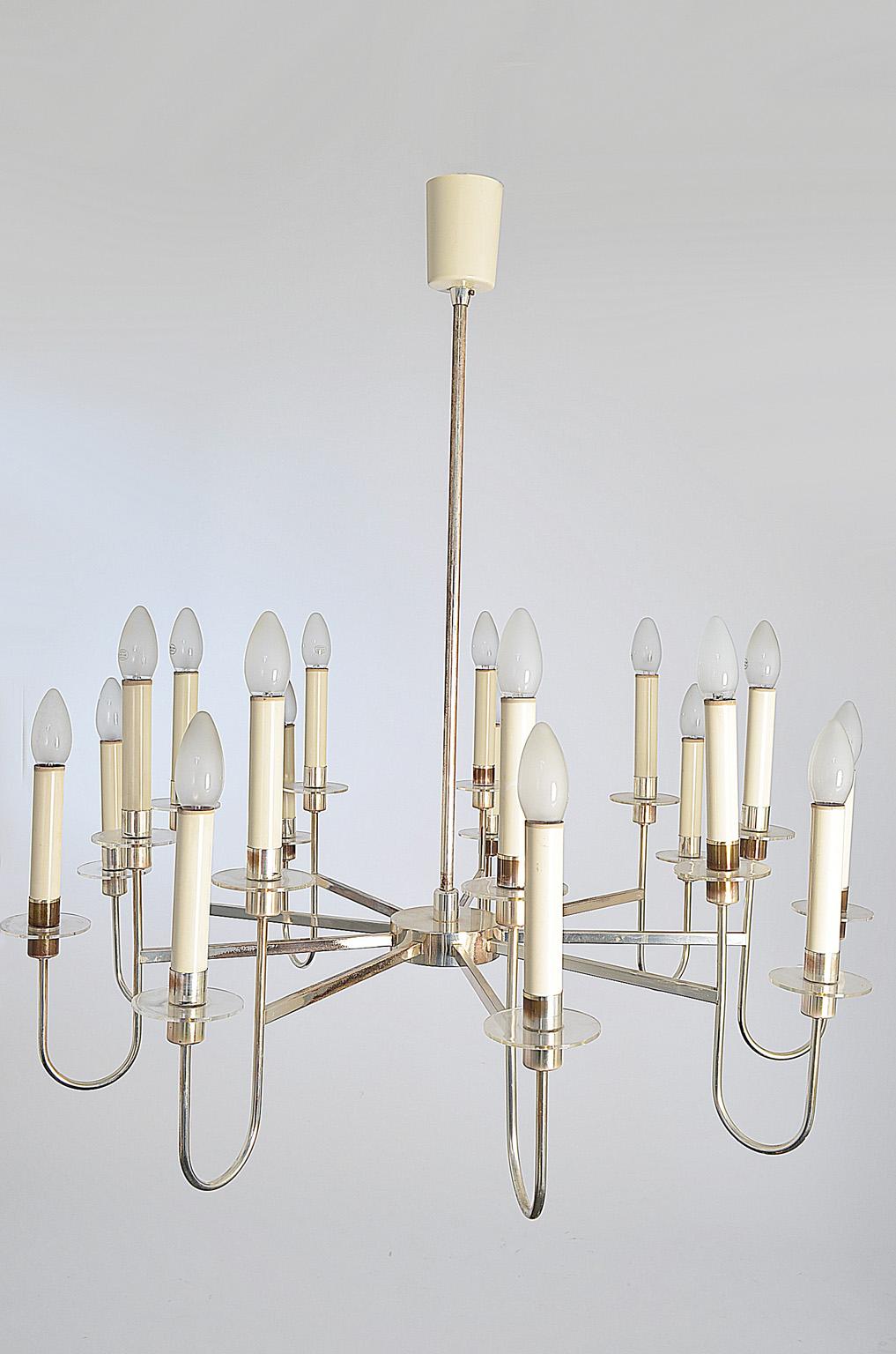 Chandelier produced by Vereinigte Werkstätten, Munich in the 1950s.
Silver plated tubular brass, partly lacquered in cream - white and transparent acrylic discs.