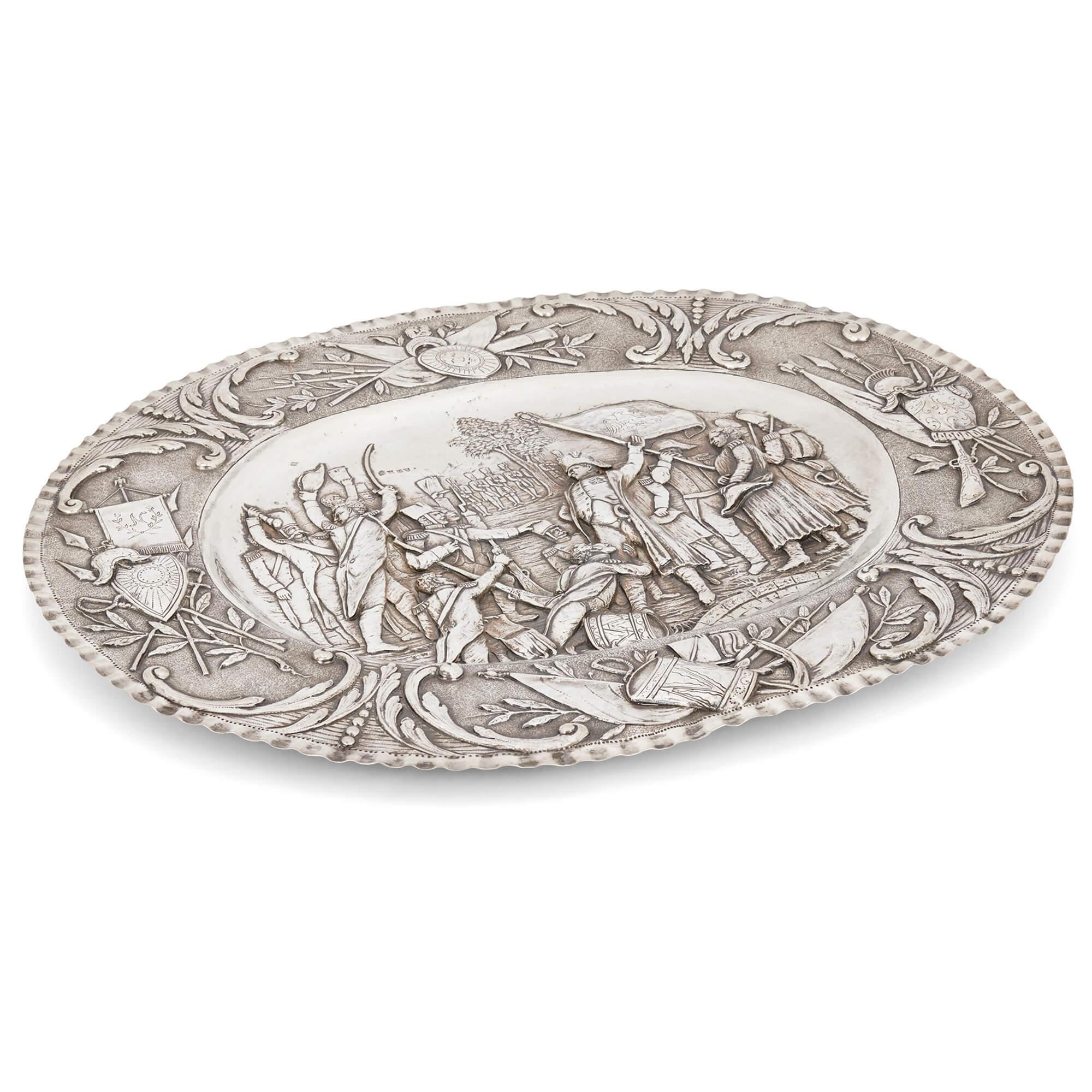 Oval-shaped silver tray by Georg Roth & Co. embossed with a Napoleonic scene
German, Late 19th Century 
Height 3cm, width 57.5cm, depth 47.5cm, weight 1.87kg

This superb piece of silverware depicts Napoleon’s return from the island of Elba in 1815,