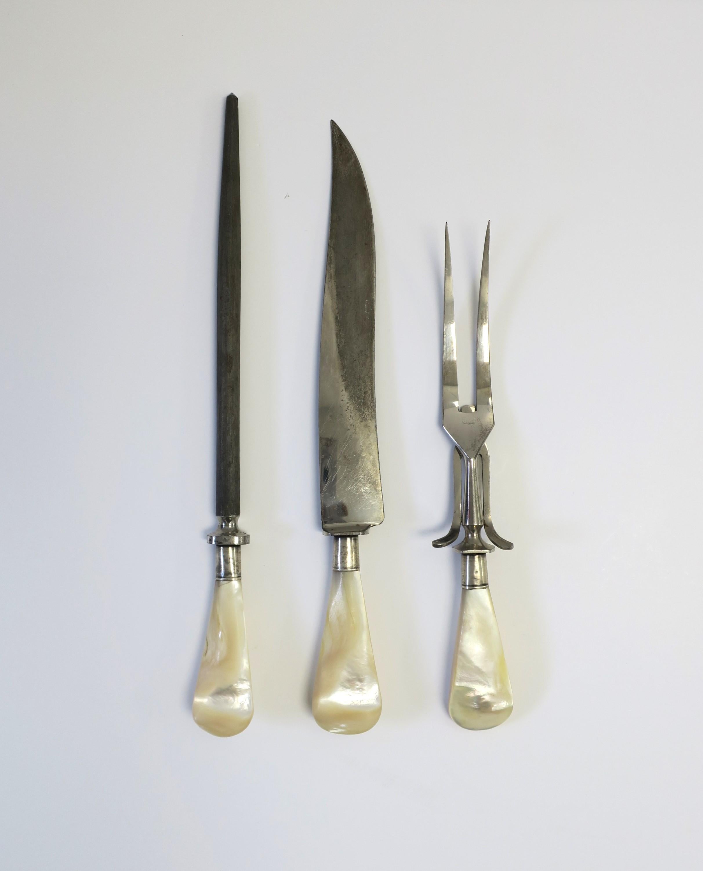 A fine stainless steel German carving set with mother of pearl handles, from Carl Wolfertz & Sohne, circa 20th century, Solingen, Germany. Set includes carving knife, fork, and sharpening steel, all with steel endcaps and mother of pearl handles.