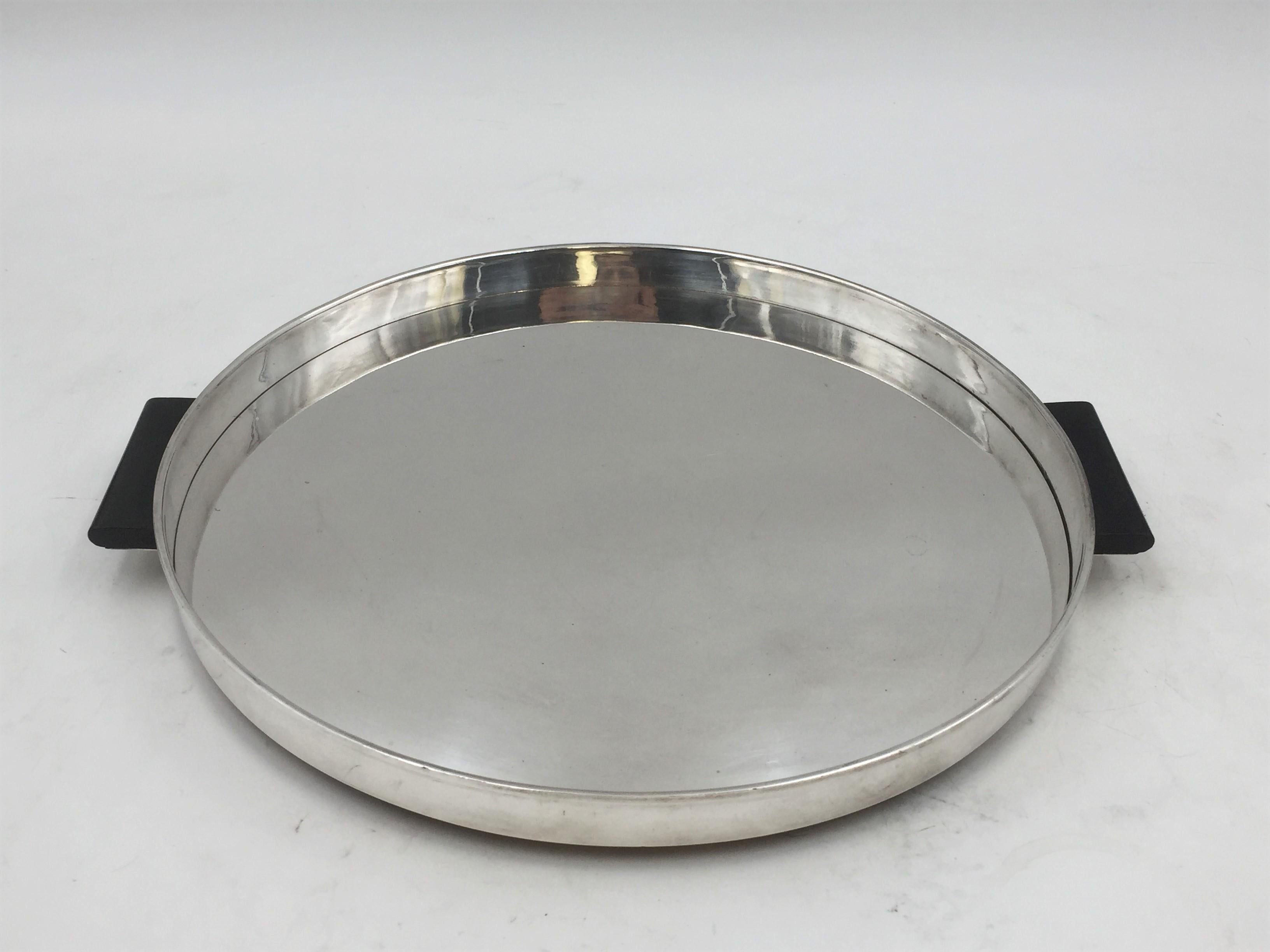 German, circular, sterling silver tray / platter standing on 4 feet with two dark wood handles whose elegant, geometrically-inspired lines are characteristic of the famed Art Deco and Bauhaus styles. It measures 11 1/4'' from handle to handle by