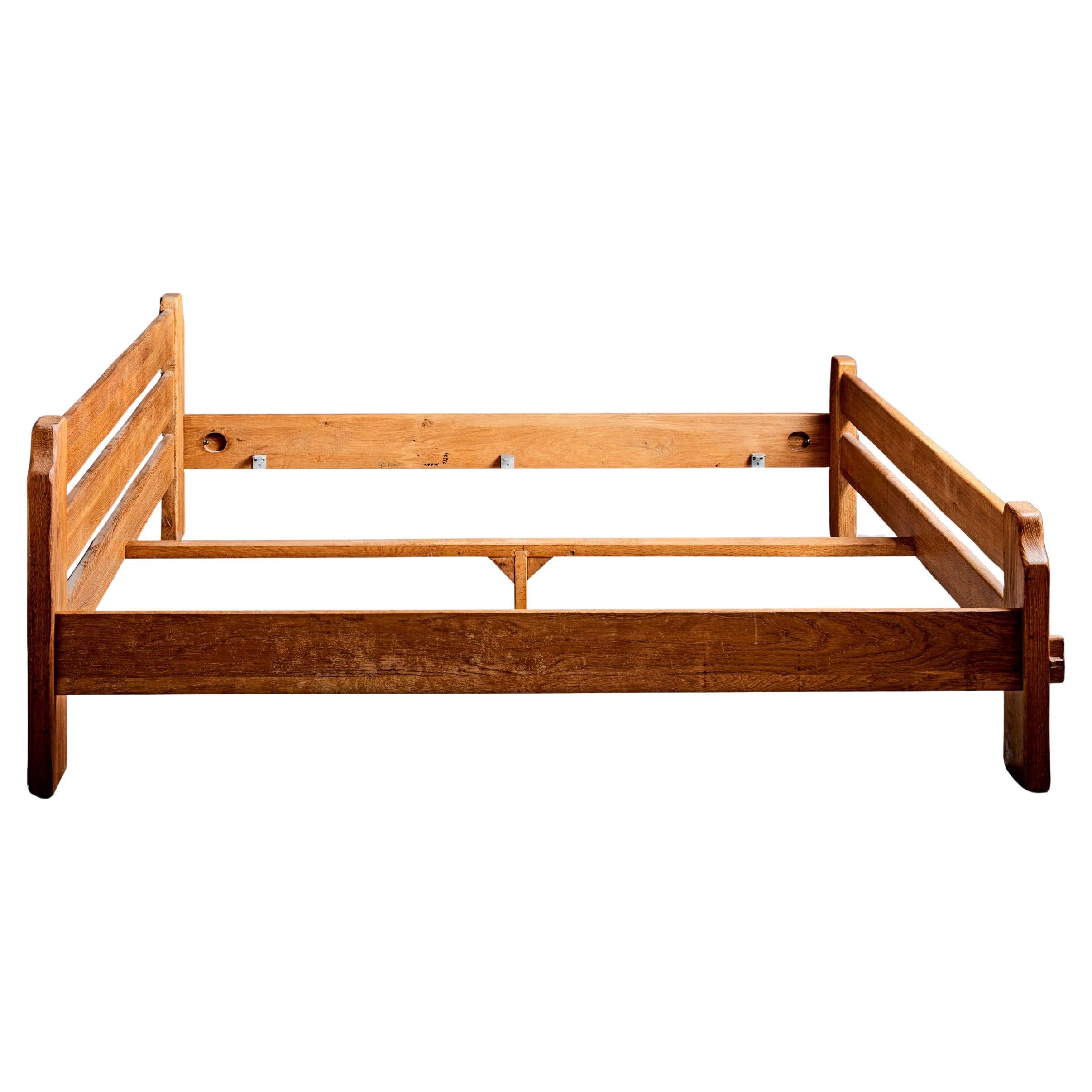 Handcrafted bed frame made from solid oak, showcasing excellent craftsmanship. This bed frame features clean lines and sturdy construction, ideal for those seeking a timeless and durable piece of furniture. The oak wood has a natural finish,