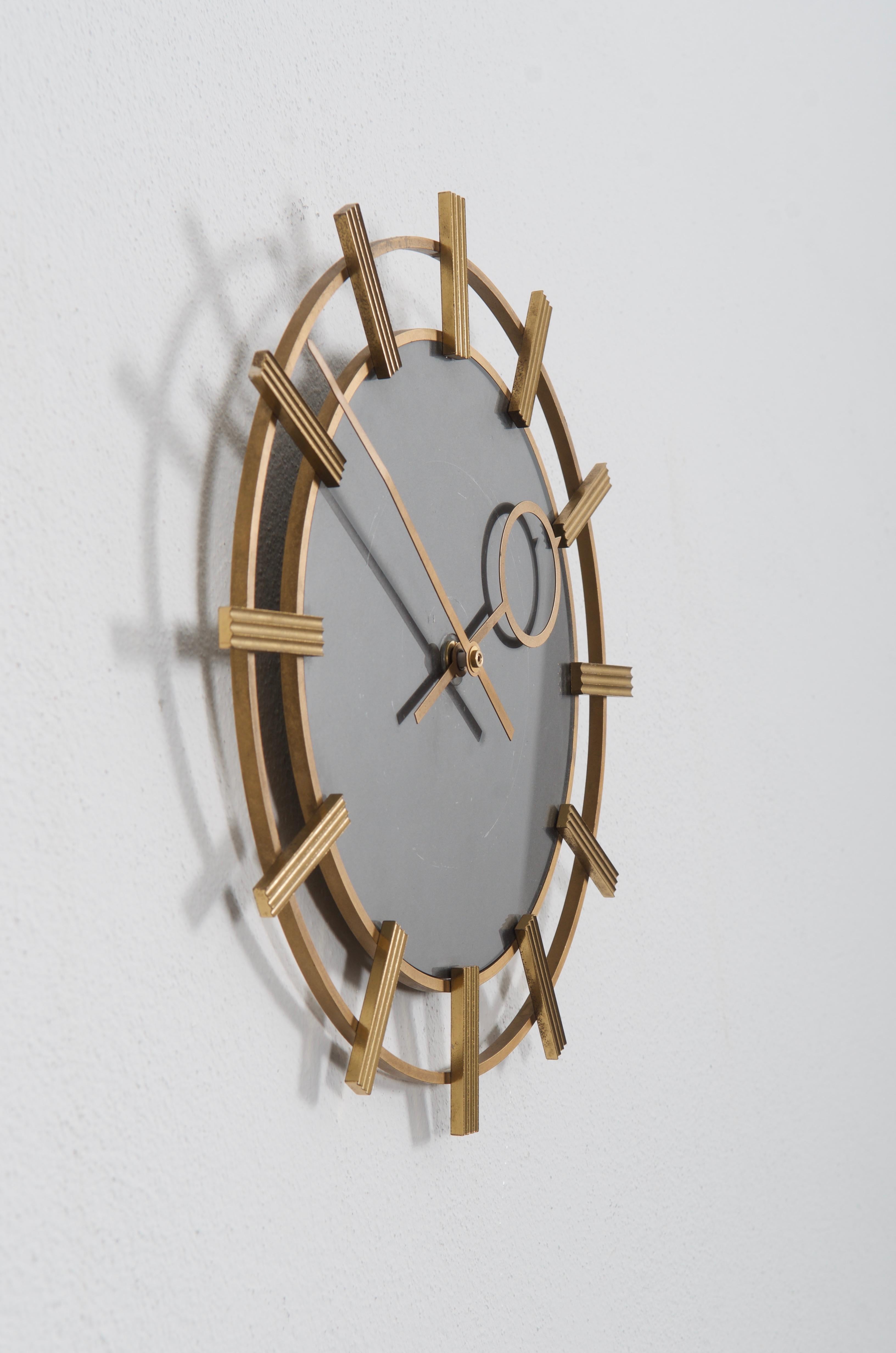 Brass frame and brass hands made by TN Telenorma in the late 1960s.
Formerly an office or factory slave clock, it is now fitted with a modern quartz movement with an AAA battery.
  