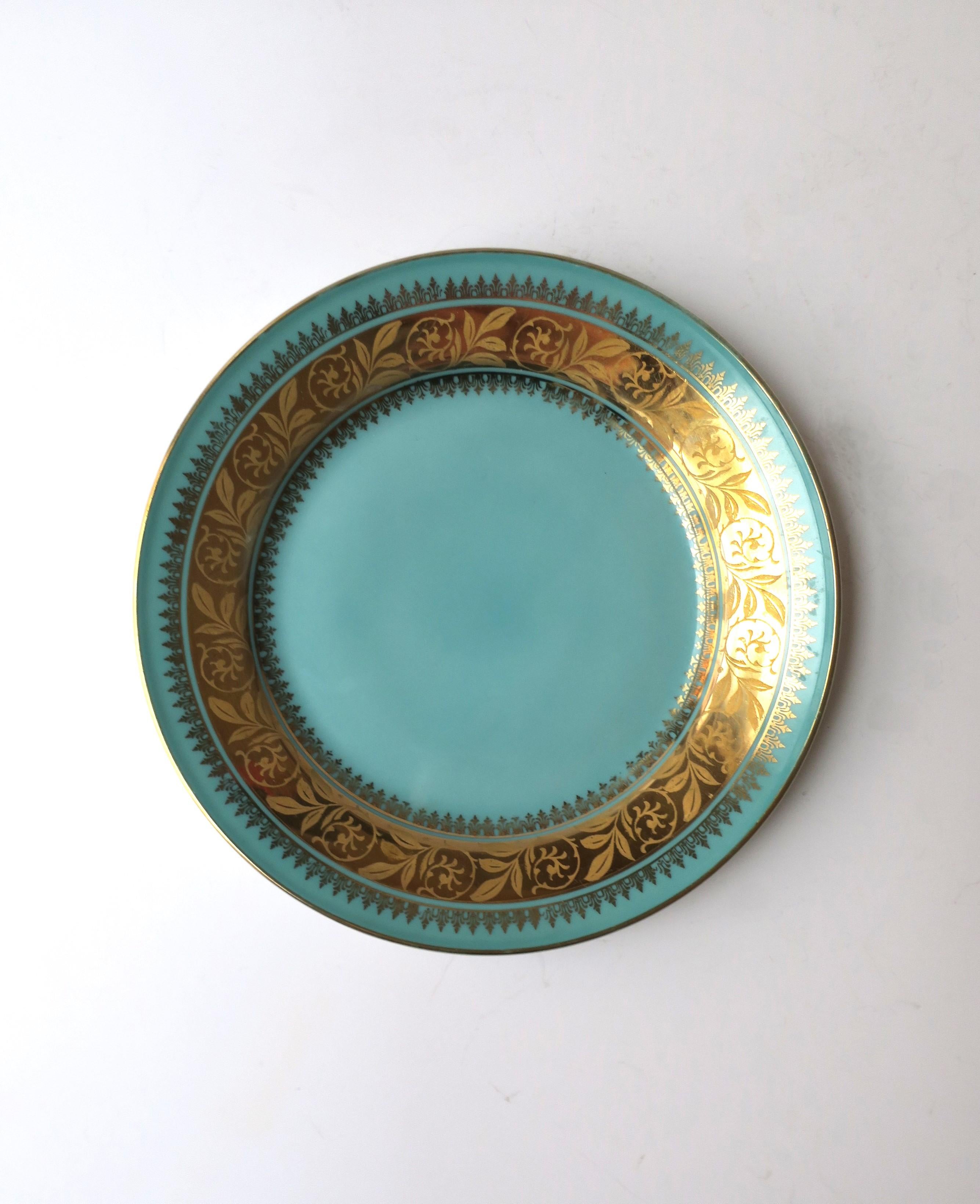 A German porcelain plate in a beautiful turquoise blue and gold, circa mid-20th century, Germany. Use to create or add to a table scape by mixing and matching (as demonstrated), use as a small plate for entertaining, etc., or use as wall art. Many