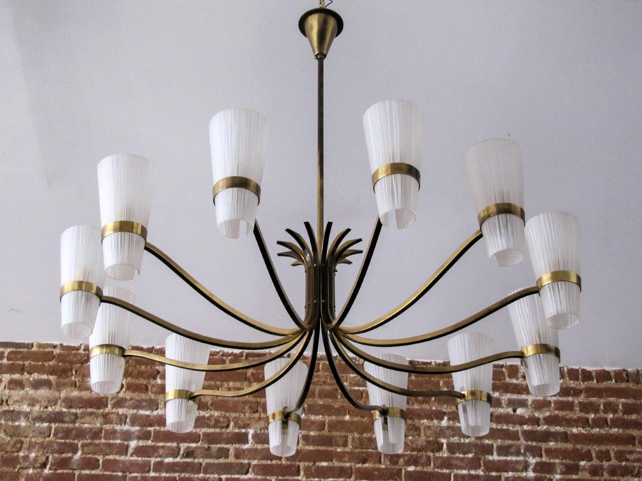 Stunning large decorative German twelve-arm brass chandelier, with two-tone brass arms and textured glass cups, wired for US standards, twelve E12 sockets, max. wattage 25w per socket, bulbs provided as a onetime courtesy.
