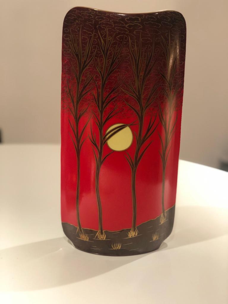 A 20th century vintage set decorative dish and vase handcrafted out of porcelain by Royal Porcelain Baravia KPM, Germany, circa 1960-1970s. The set features a red background with black and gold leaf trees and a bright yellow moon.
Measures: Vase 32