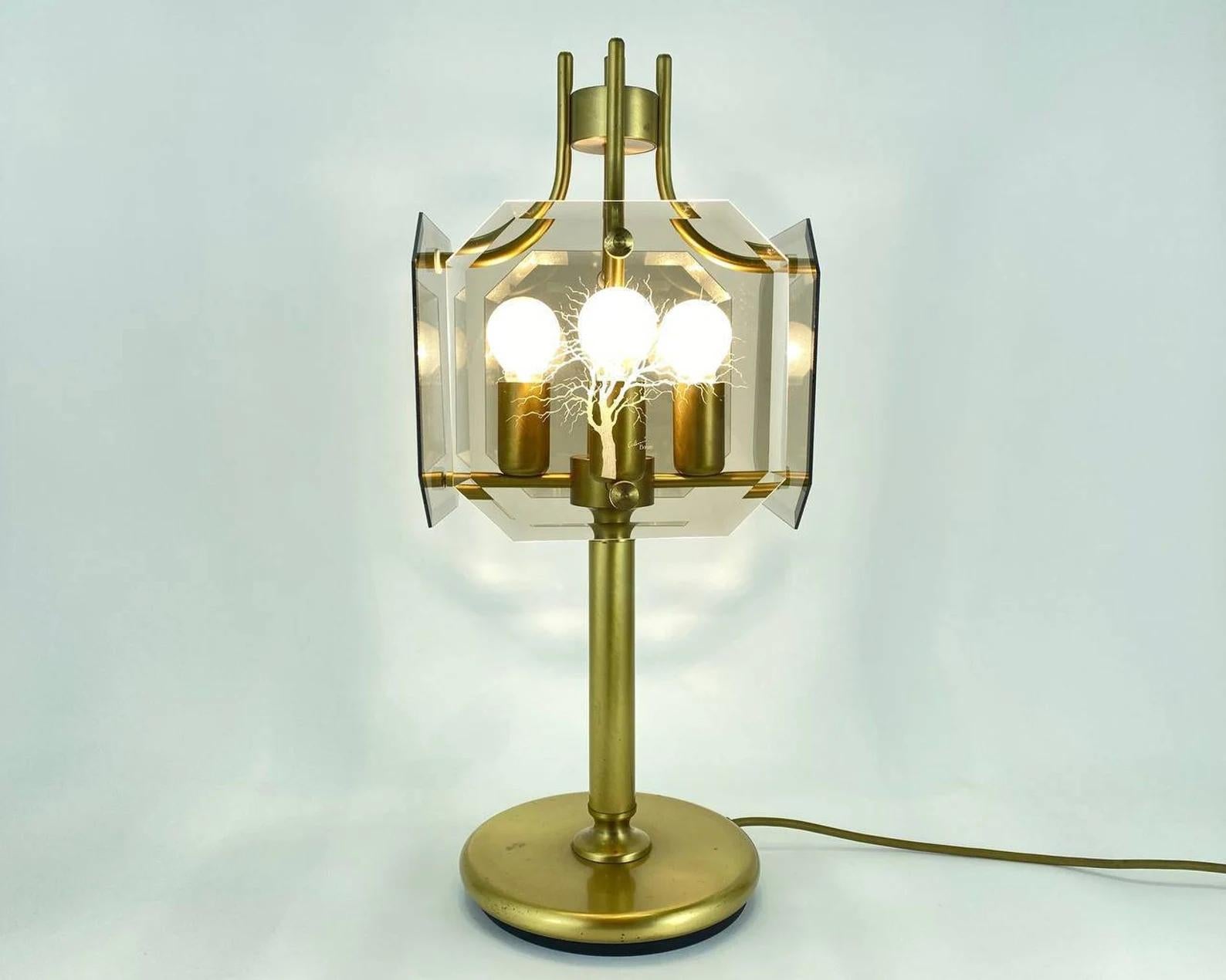 Large table lamp designed by renowned designer Luigi Colani for Sische. Made of brass and smoked glass with decorative engraved trees.

The lamp is signed.

Functional and elegant model will be a worthy addition to the interior.

Designed for