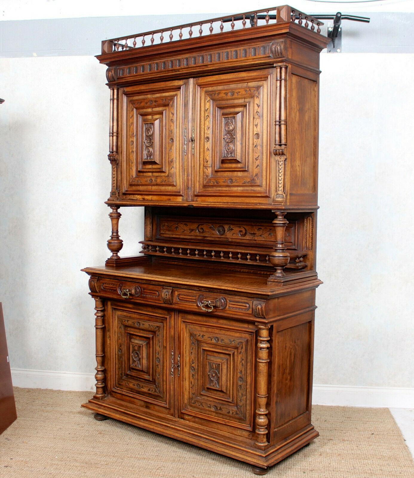 A fine quality 19th century German carved walnut cabinet.
The gallery top above two large foliate cushion carved and moulded doors enclosed removable shelving, carved back panel and gallery flanked and raised on turned reeded columns. The lower
