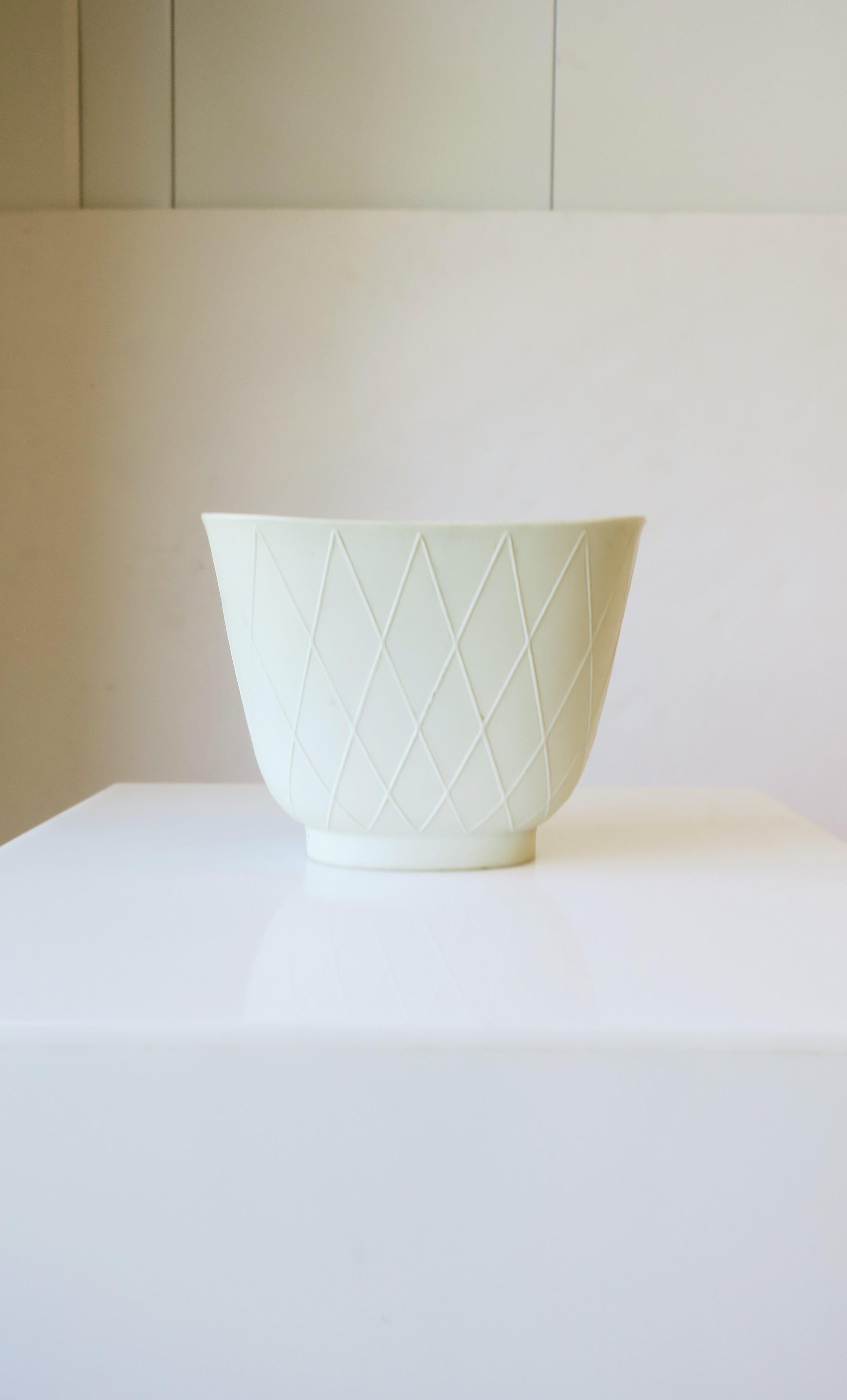 A beautiful white to stone-white German porcelain oblong vase by Rosenthal, circa early-20th century, Germany. A matte exterior with a beautiful raised harlequin pattern. Glazed interior. Marking's on underside as shown in image #17. Dimensions: