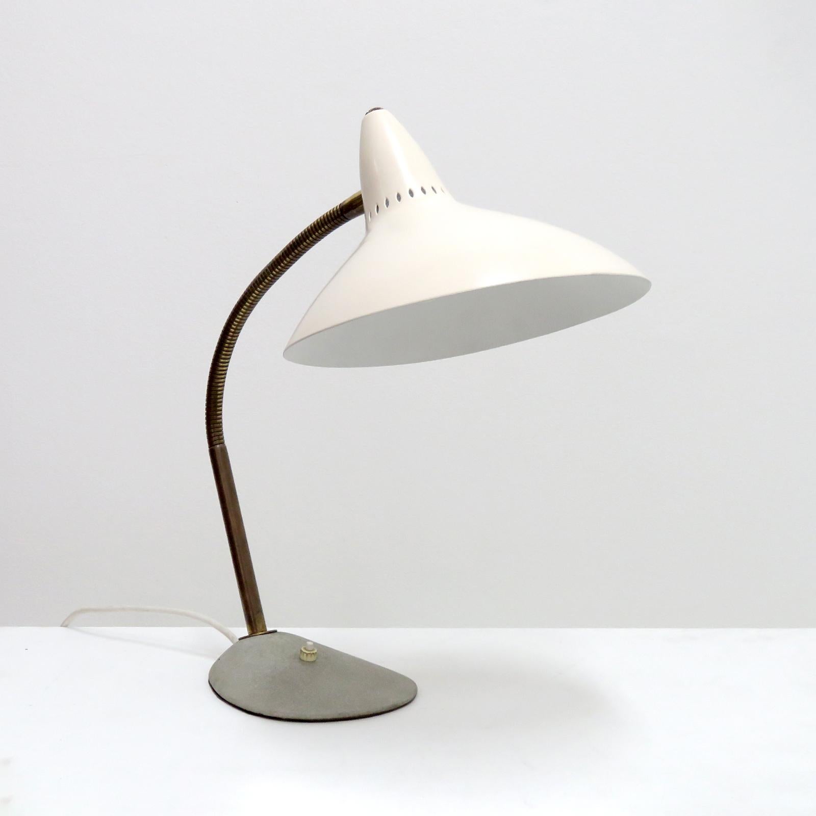 wonderful 1950's German table lamp with egg shell colored 'witches hat' shade on a flex brass arm and a grey base with individual on/off switch. Wired for US standards, one E26 socket, max. wattage 75w, bulb provided as a onetime courtesy.