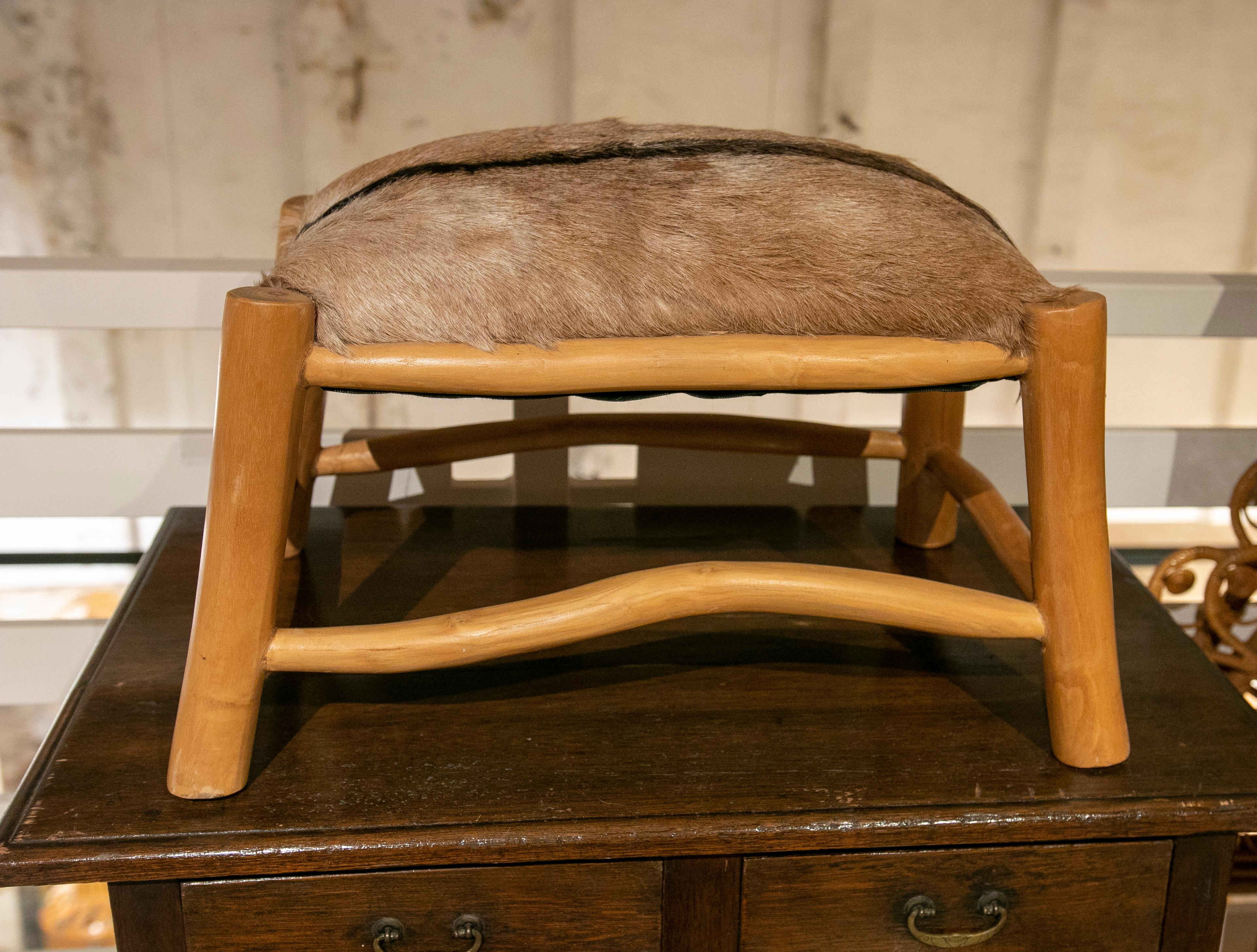 German wooden stool with a fallow deer leather seat.

