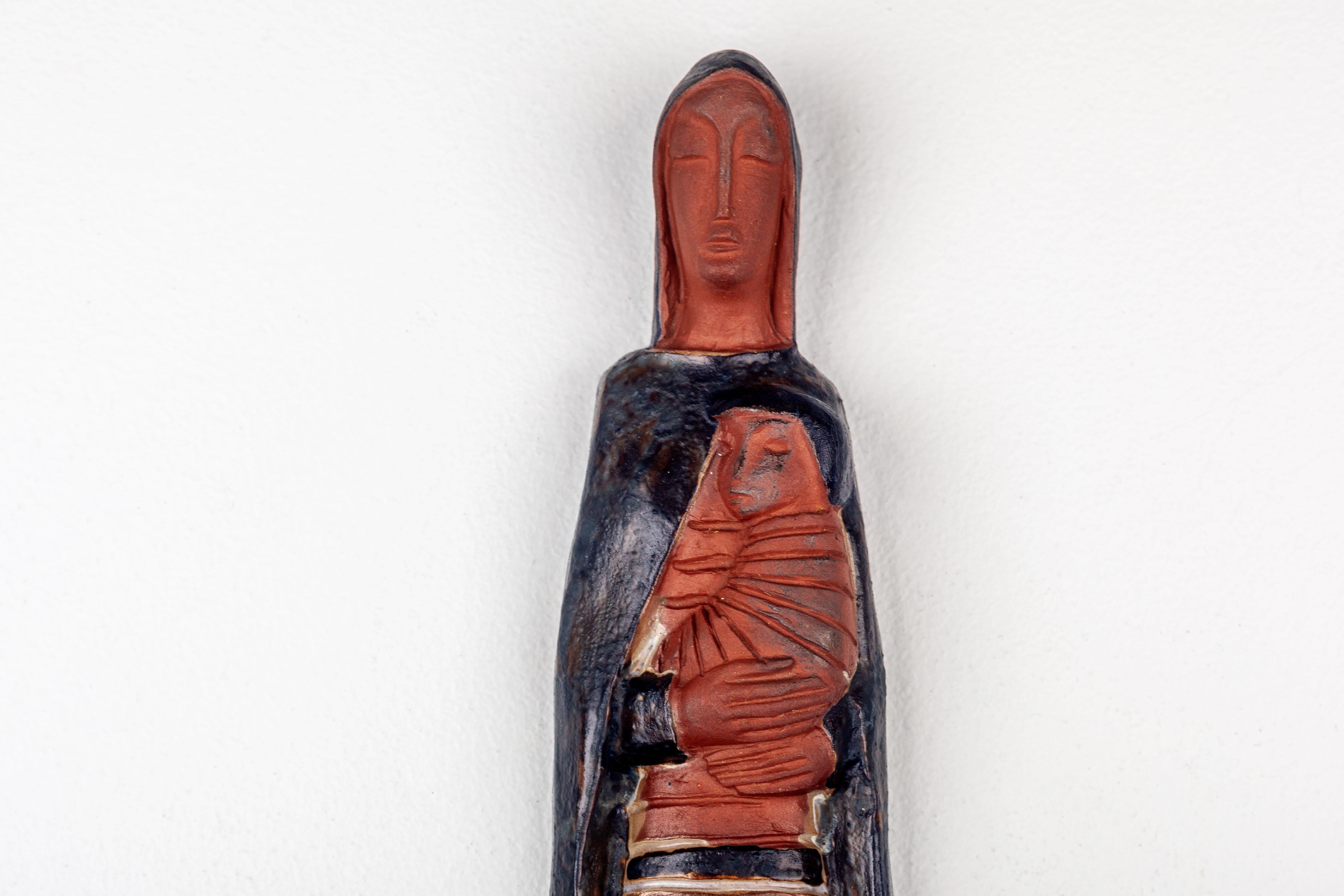 10-inch Virgin Mary and Child Jesus, draped in a hooded cape and a striped dress in terracotta and black. A serene Virgin Mary and a captivated Child Jesus, both with their head covered.

Our European cross collection (Tradition & Modernism) is