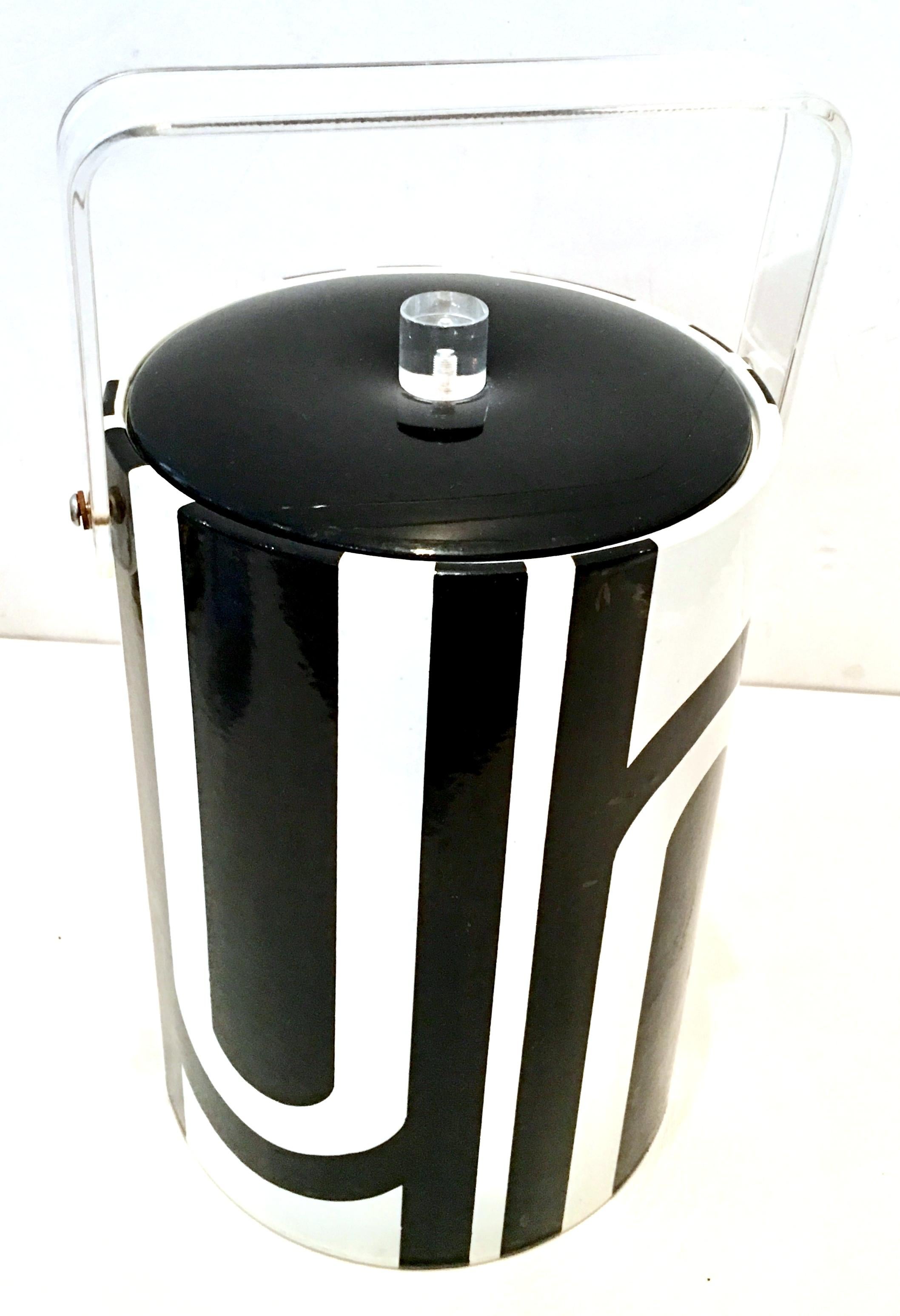 20th Century MOD black and white geometric thermal Lucite and vinyl lidded and handled tall ice bucket by, Georges Briard. Signed on the exterior front and underside Georges Briard.
This tall cooler is insulated and features a Lucite cylinder knob