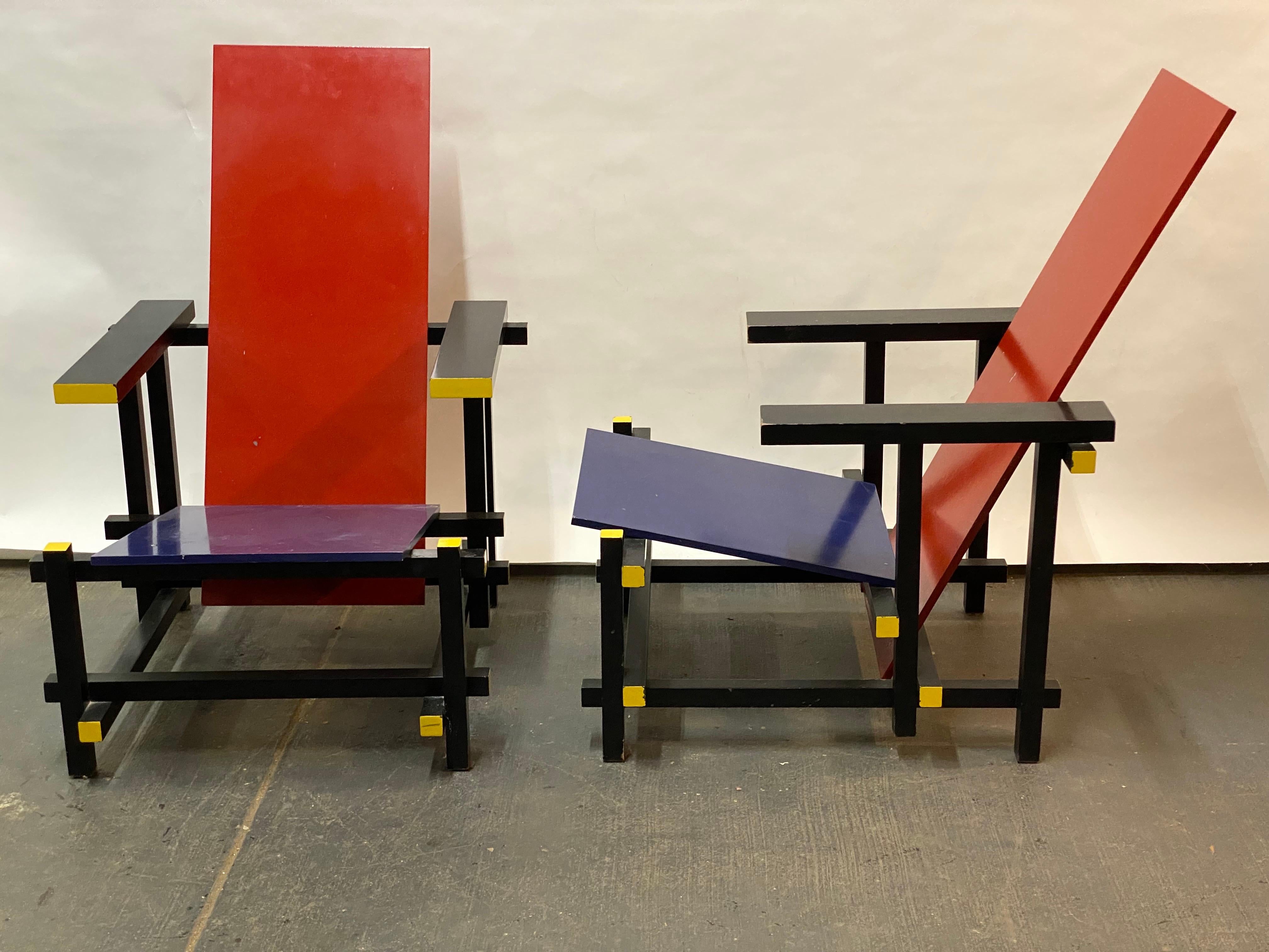 A smart pair of Gerrit Rietveld Red and Blue DeStijl style lounge chairs. Surprisingly comfortable while being so angular. The original was produced circa 1918. These were produced in the 1980s when there was a total upswing in very early modern