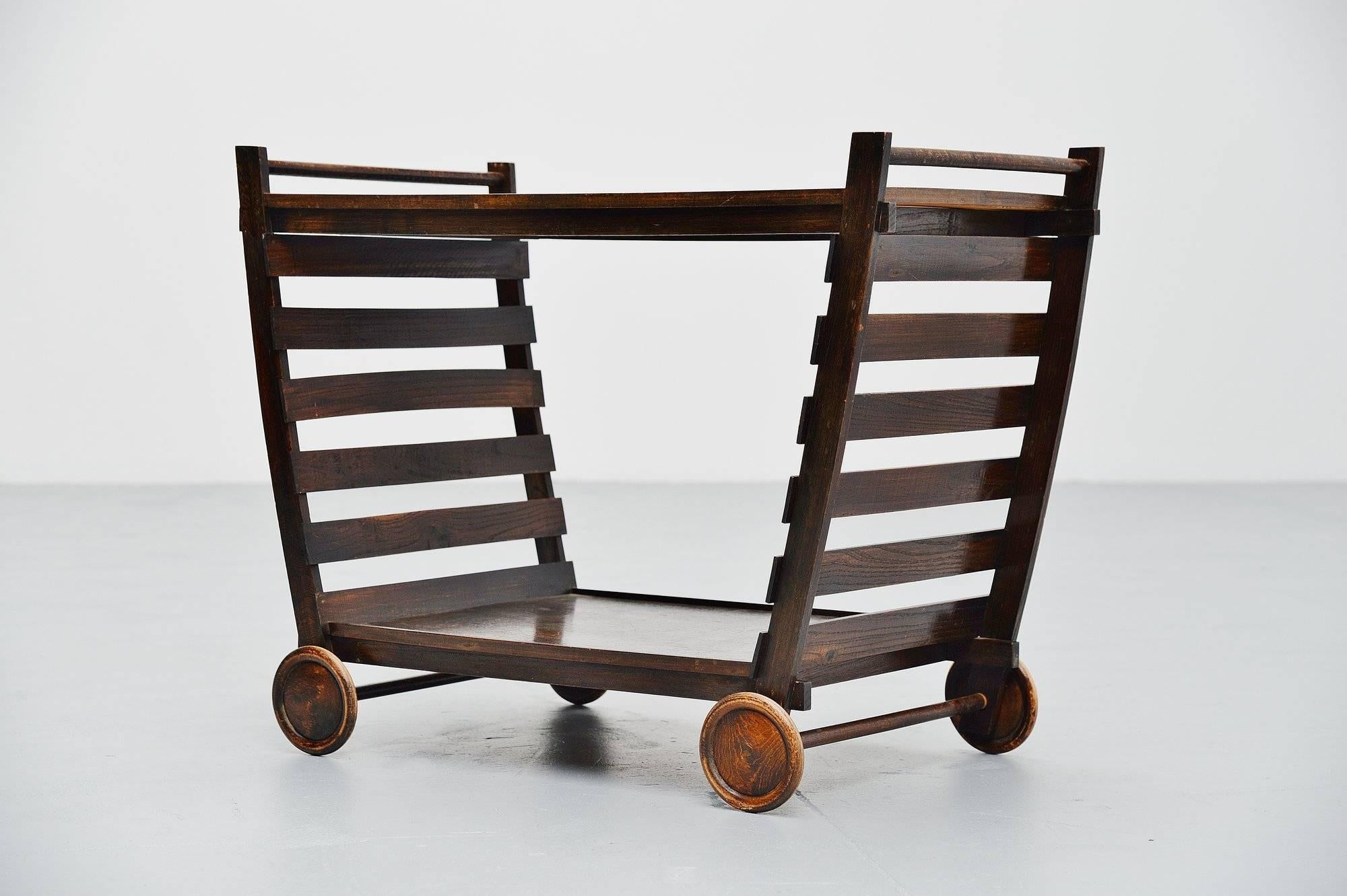Ultra rare and quite unique tea cart designed by Gerrit Thomas Rietveld, designed and made probably by Gerard van de Groenekan for Metz & Co ca 1945. This tea cart is one of the very few known to still exist because the wood is very fragile and