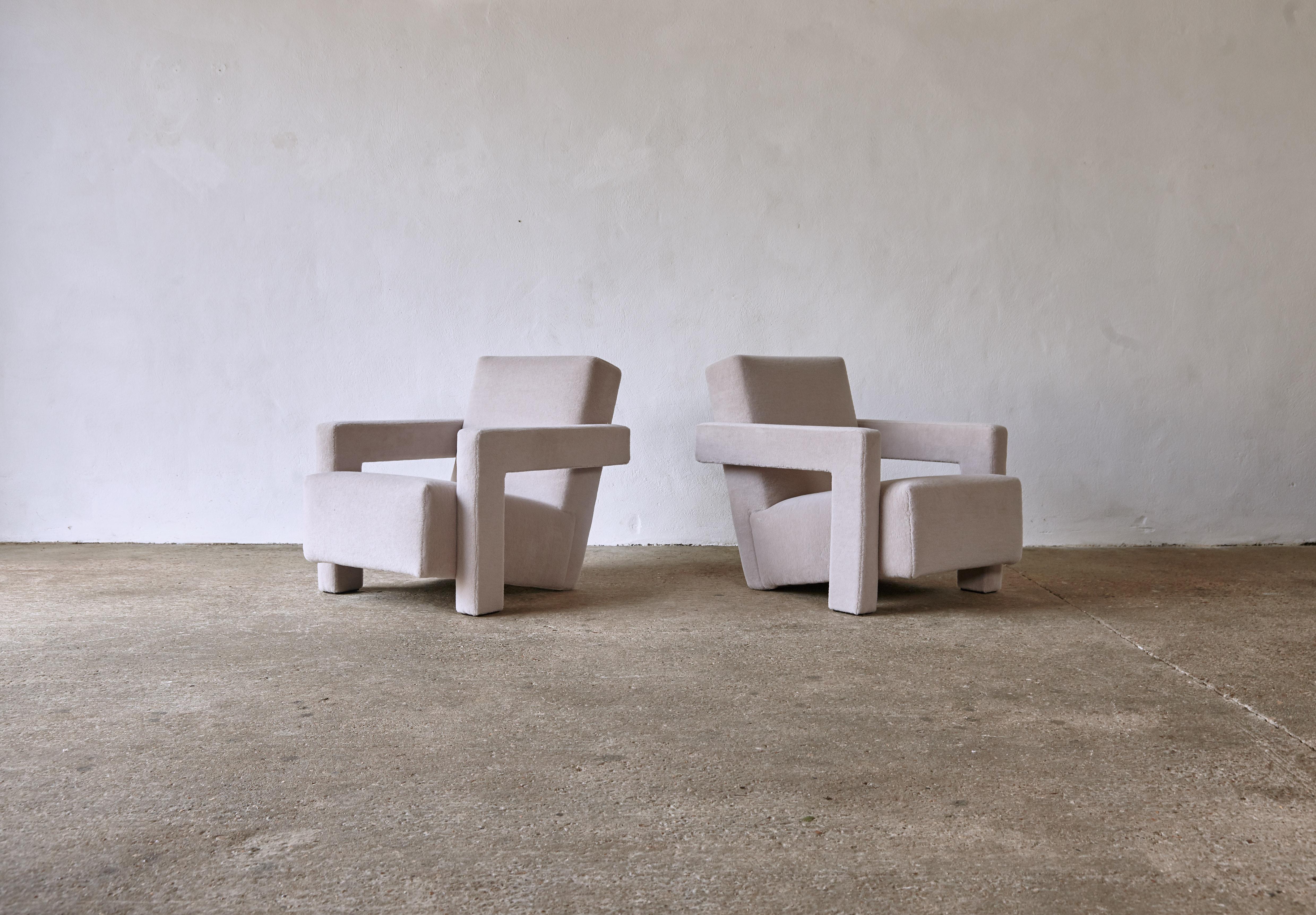 A pair of Gerrit Rietveld Utrecht armchairs, produced by Cassina, and newly upholstered in a light grey / silver thick, soft, luxurious 100% alpaca pile fabric. Cassina labels to the underneath. Priced and sold as a pair together.  Fast shipping