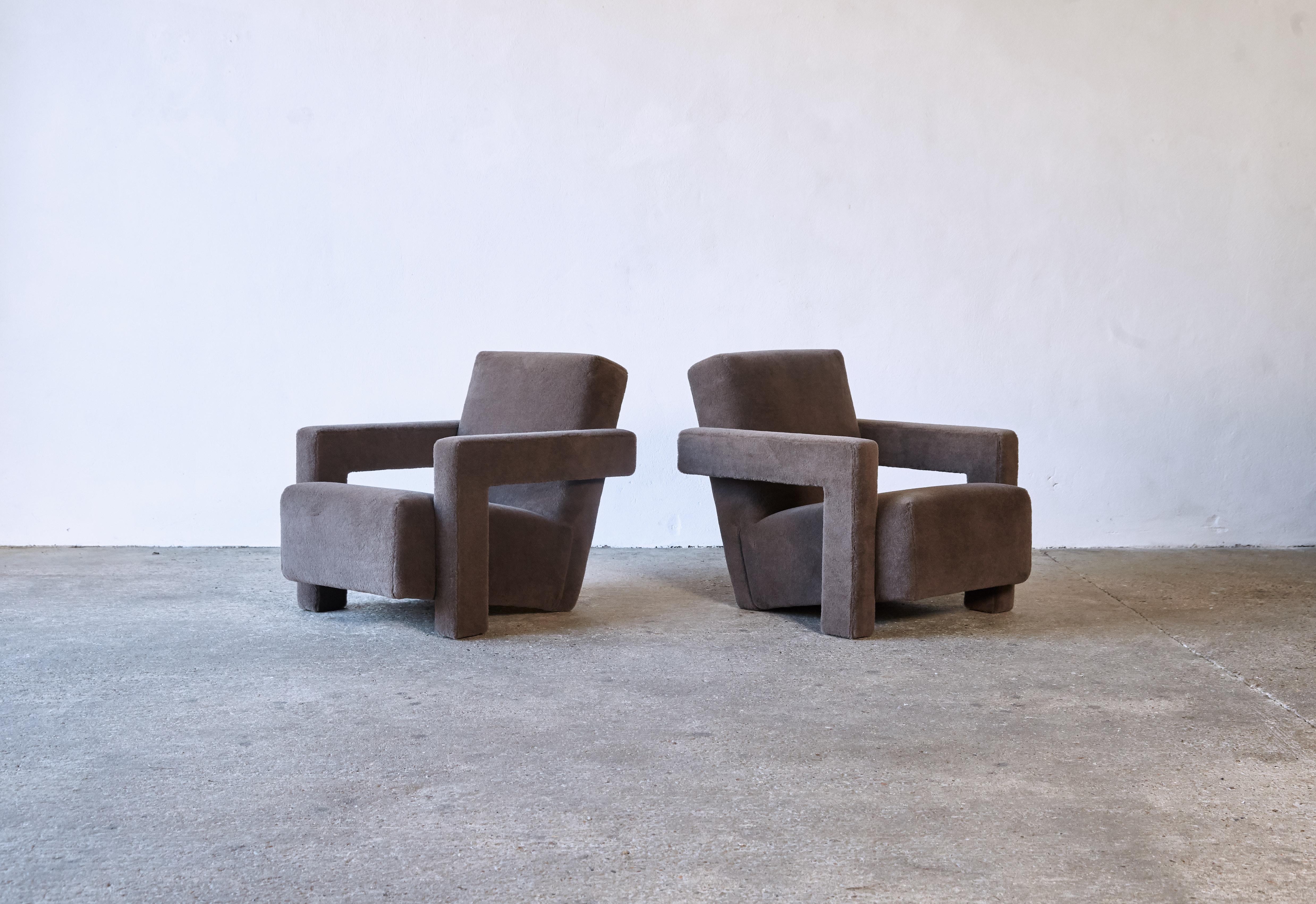 A pair of Gerrit Rietveld Utrecht armchairs, produced by Cassina, and newly upholstered in a brown / grey thick, soft, luxurious 100% alpaca pile fabric. Cassina labels to the underneath. Priced and sold as a pair together. Fast shipping worldwide -