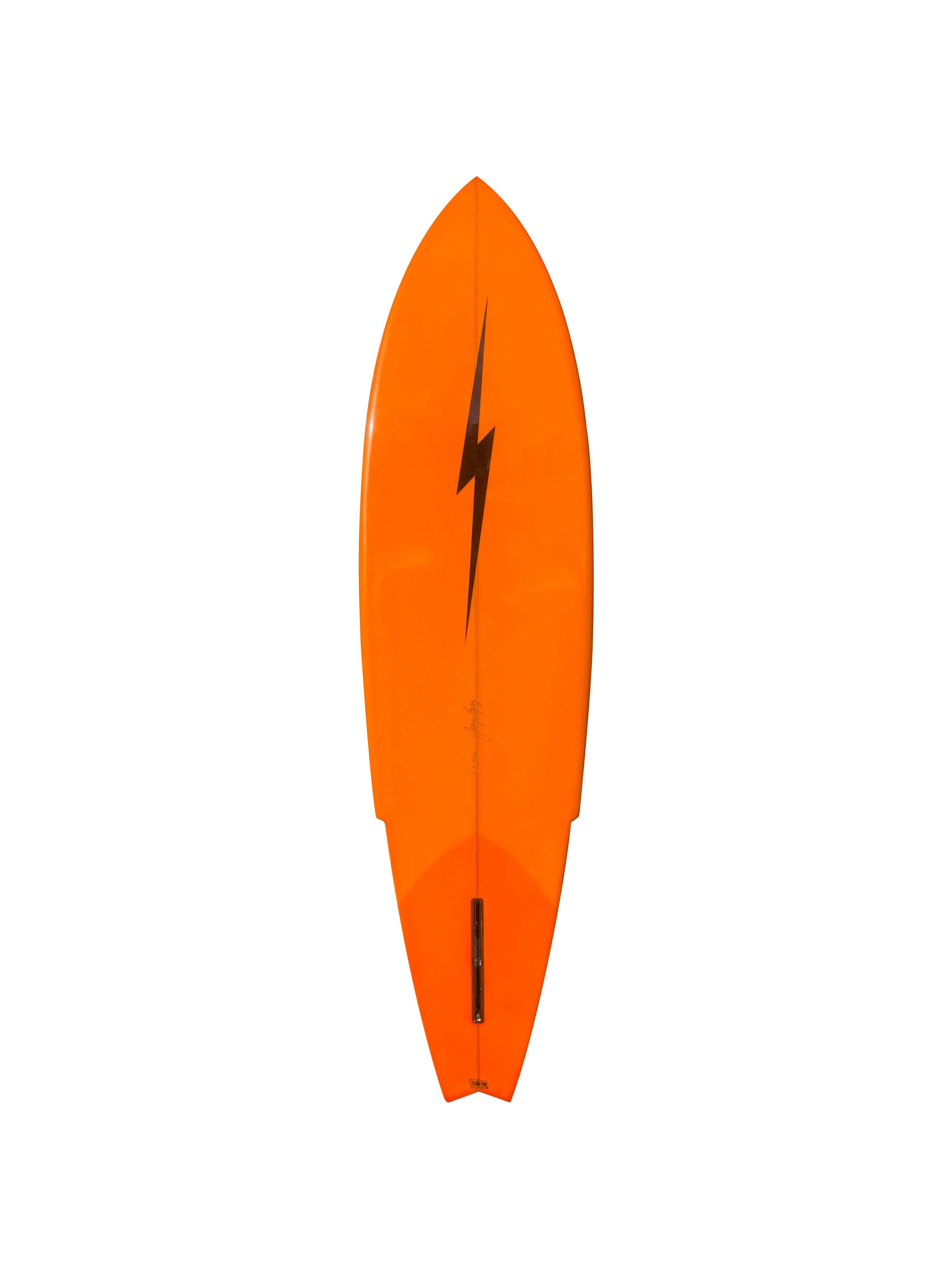 ‘Sting’ model surfboard shaped by Gerry Lopez. Bold red deck tint with orange wrapped rails/bottom. Shaped by Gerry “Mr. Pipeline” Lopez, the revered surfer, shaper, journalist, film actor, and co-founder of Lightning Bolt Surfboards. 6’8″ 'Sting'