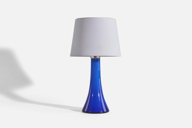 A pair of blue glass table lamps designed by Gert Nyström and produced by Hyllinge Glasbruk, Sweden, 1960s. 

Sold without Lampshade(s).
Dimensions of Lamp (inches) : 13.68 x 5.38 x 5.38 (Height x Width x Depth)
Dimensions of Shade (inches) : 8 x 10