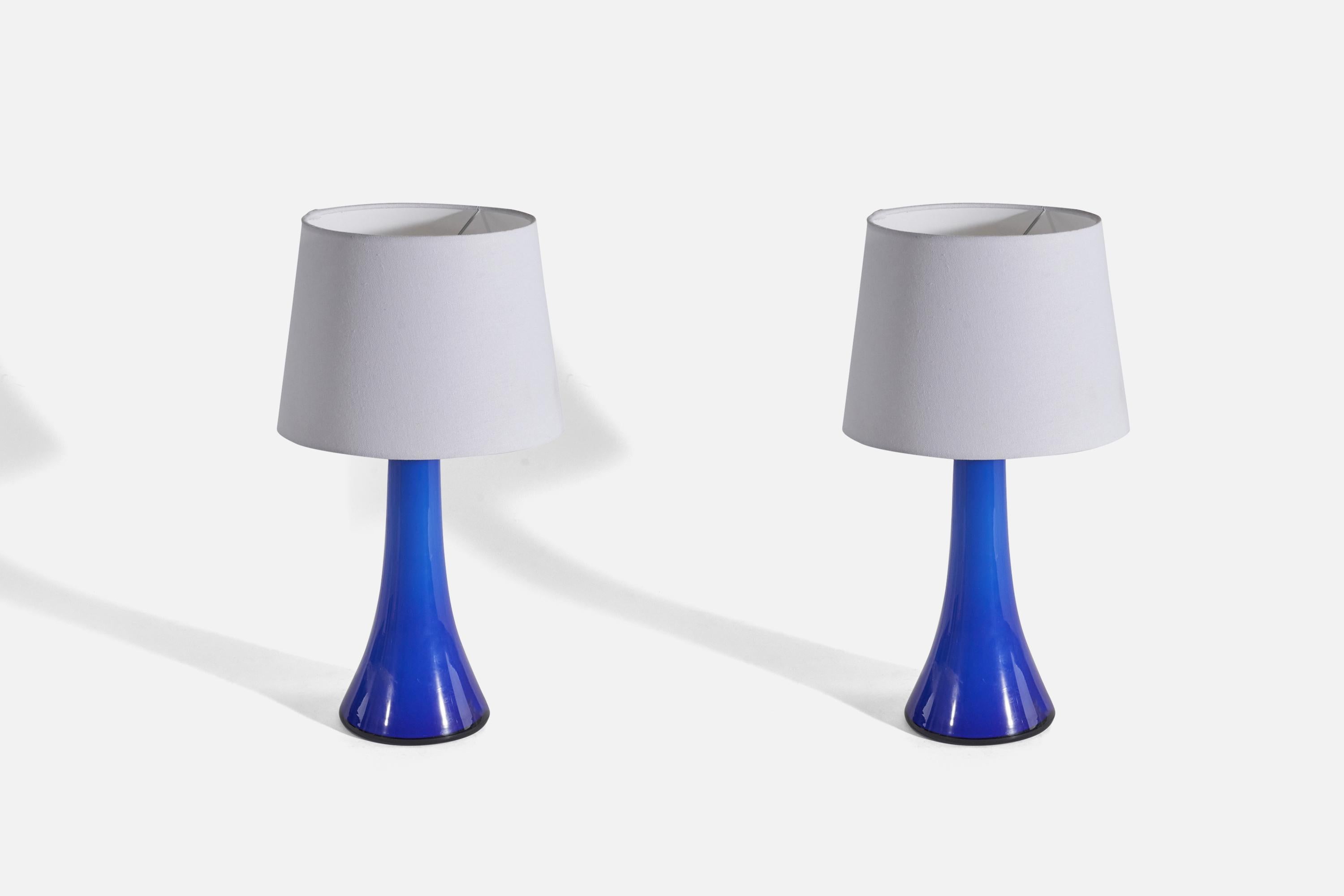 A pair of blue glass table lamps designed by Gert Nyström and produced by Hyllinge Glasbruk, Sweden, 1960s. 

Sold without Lampshade(s).
Dimensions of Lamp (inches) : 13.68 x 5.38 x 5.38 (Height x Width x Depth)
Dimensions of Shade (inches) : 8 x 10