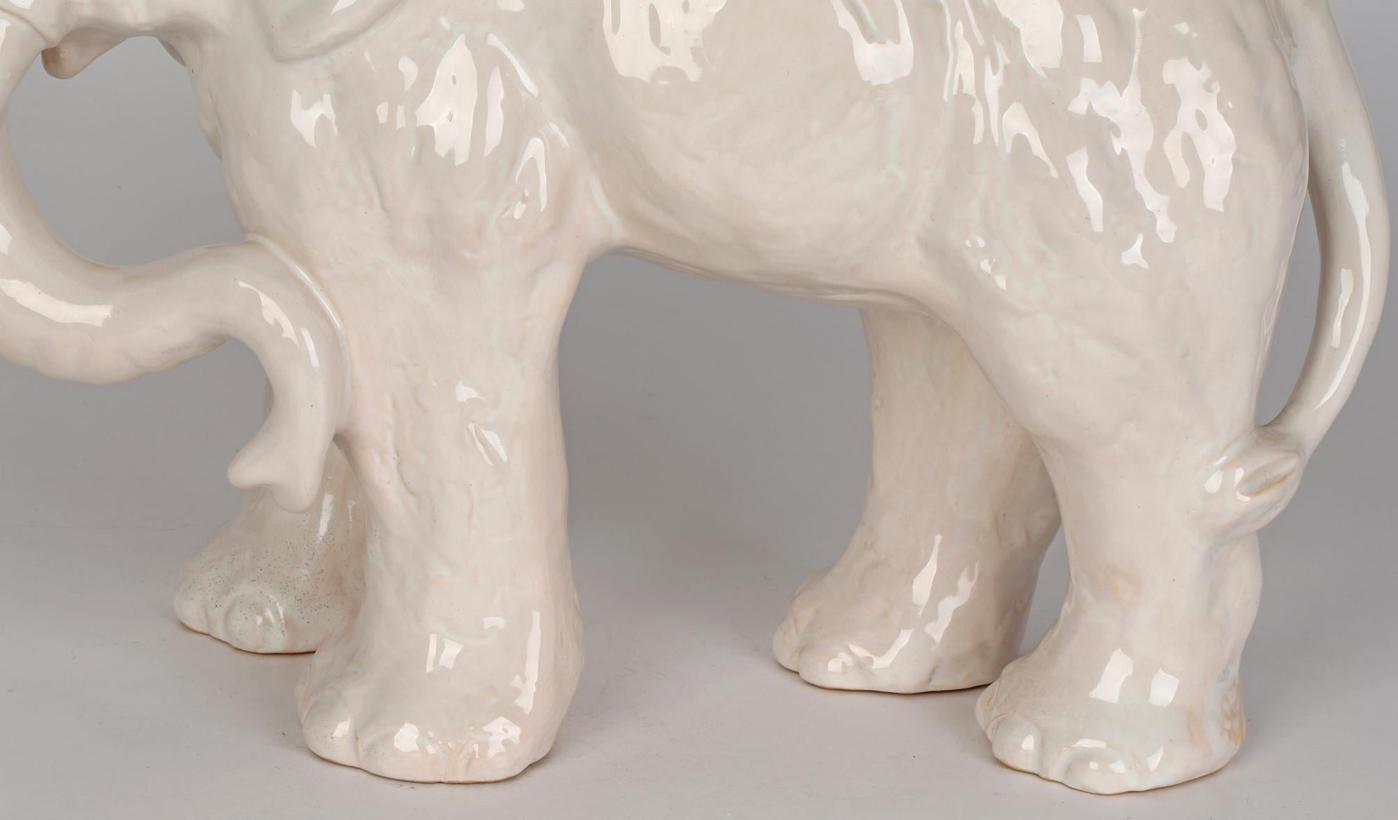 A very impressive and large Danish Art Deco L Hjorth (Bornholm) art pottery elephant decorated in white glazes by Gertrud Kudielka (1896-1984) and dating from around 1930. This large stoneware elephant is naturalistically modelled in a standing pose