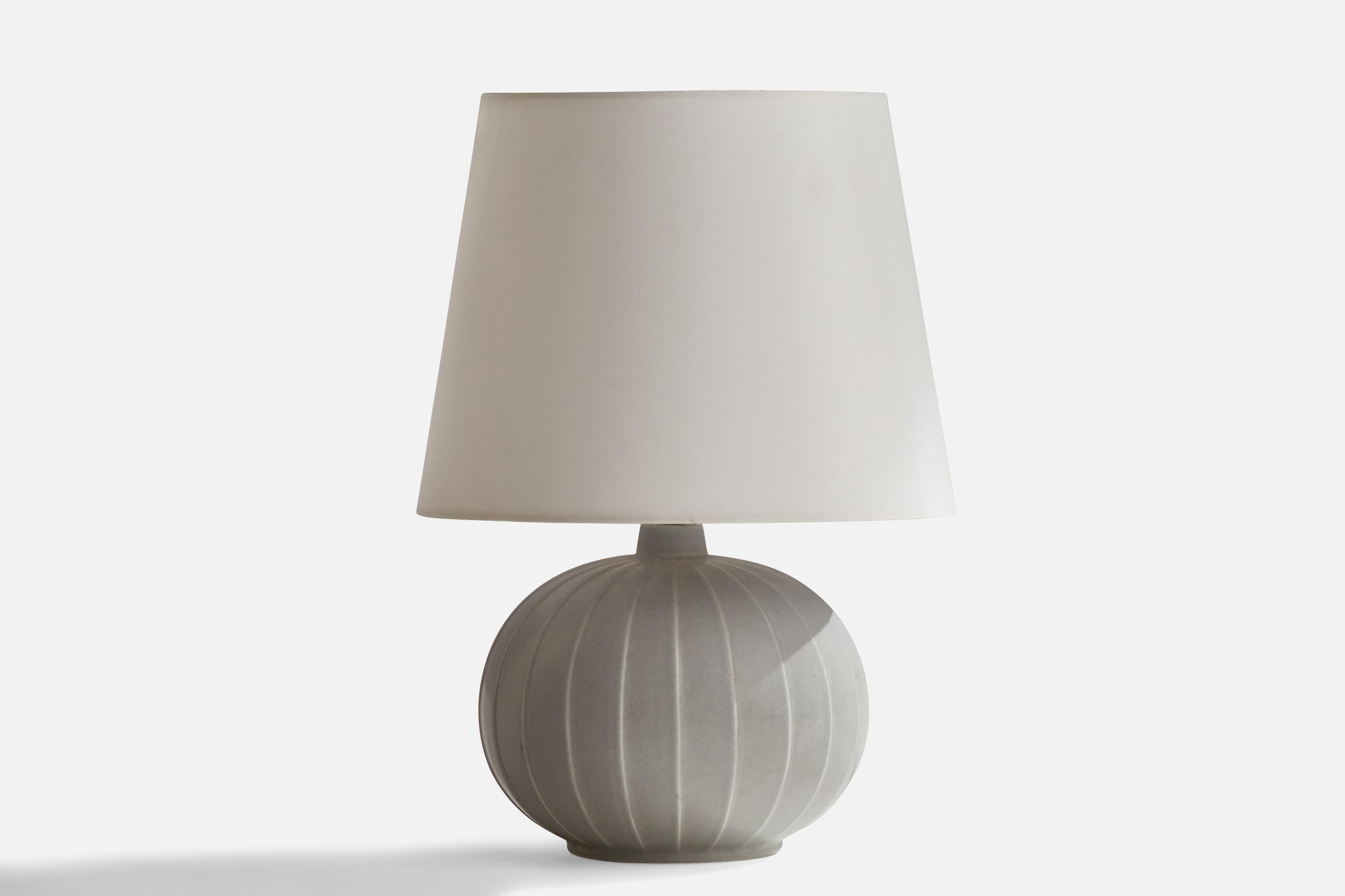 A fluted light-grey stoneware table lamp, design attributed to Gertrud Lönegren produced by Rörstrand, c. 1940s.

Dimensions of Lamp (inches): 13.75” H x 7” Diameter
Dimensions of Shade (inches): 7.5” Top Diameter x 10”  Bottom Diameter x 8”