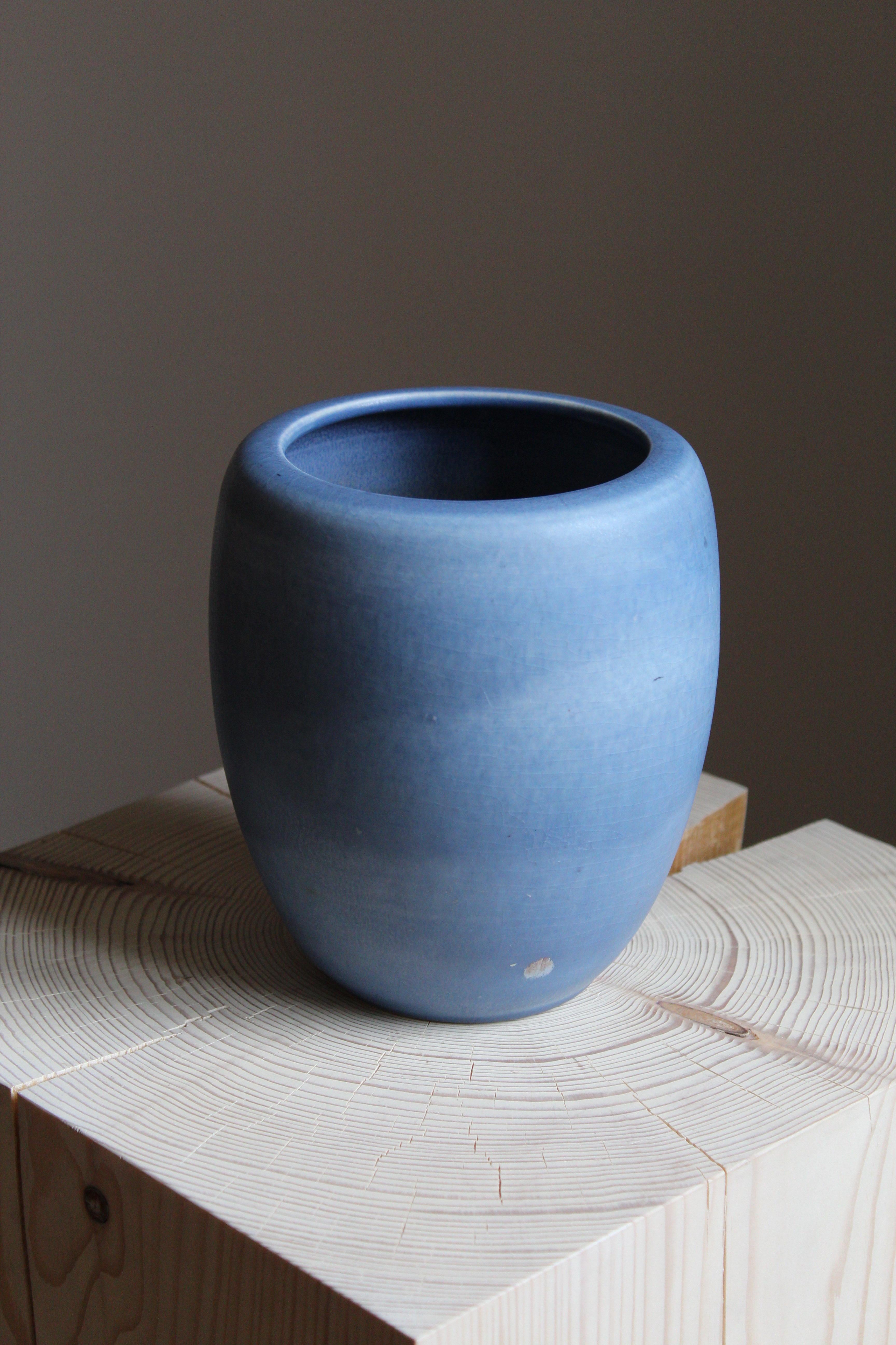 A vase, designed by Getrud Lönegren. Produced by Rörstrand. Stamped. Features blue glaze with subtle detailing. 

Other designers of the period include WIlhelm Kåge, Stig Lindberg, Axel Salto, Arne Bang, and Gunnar Nylund.