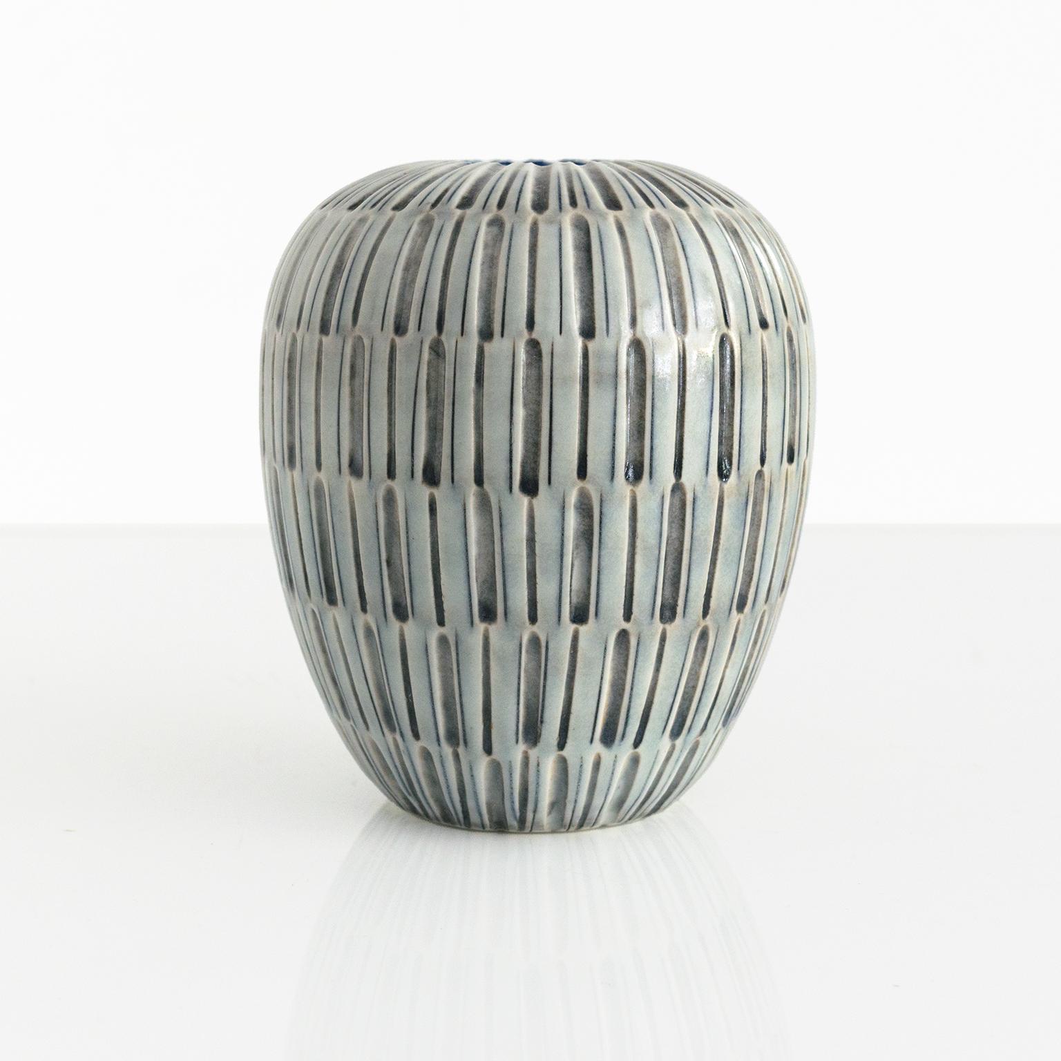 Gertrud Lonegren textured vase with bands of vertical patterns in neutral blue and gray. This studio pieces was created at Rorstrand between 1937-42

Measures: Height: 6.25“ Diameter: 5“.