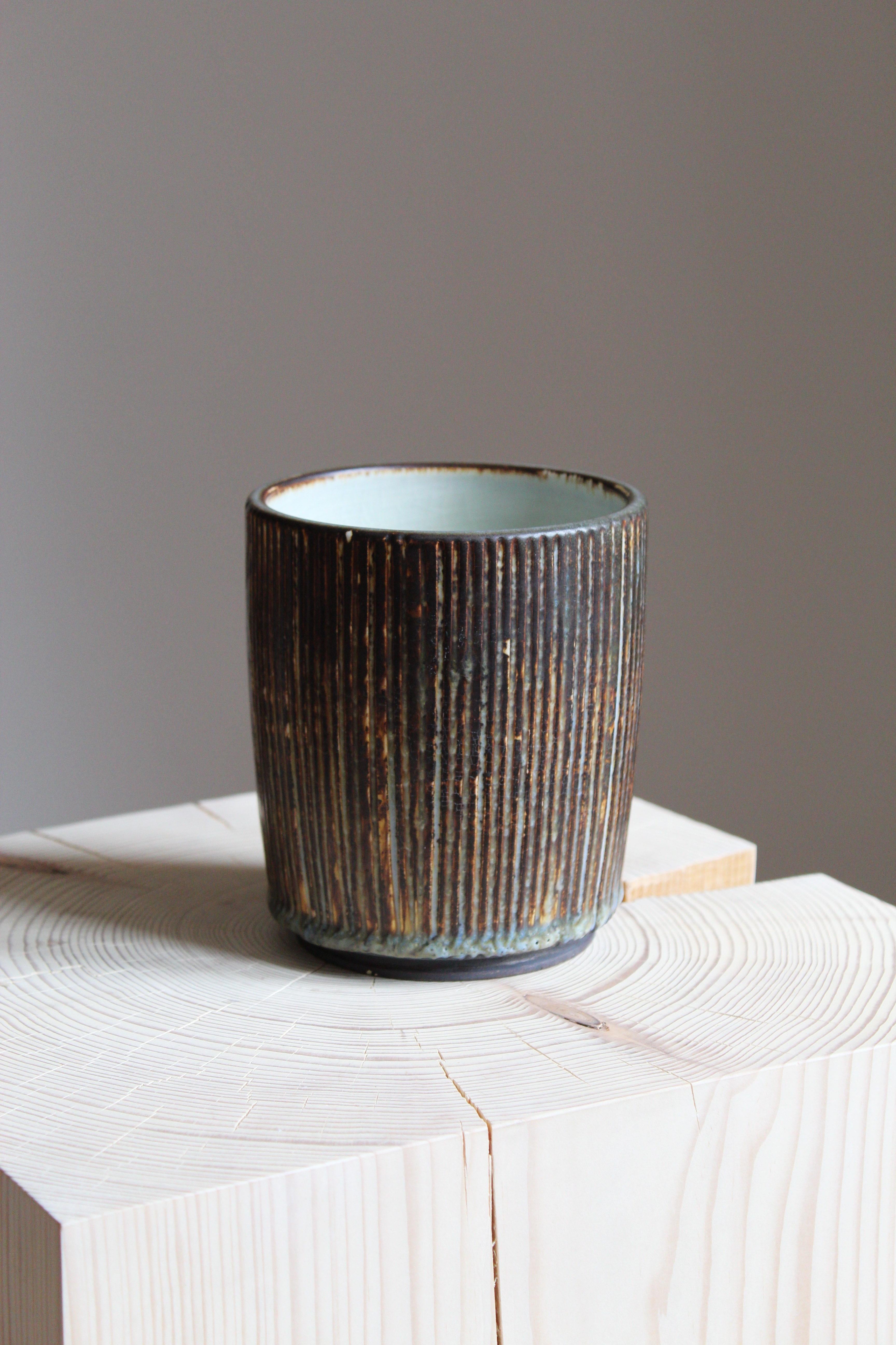 A small vase, designed by Getrud Lönegren. Produced by Rörstrand. Stamped. Features a highly artistic glaze.

Other designers of the period include WIlhelm Kåge, Stig Lindberg, Axel Salto, Arne Bang, and Gunnar Nylund.