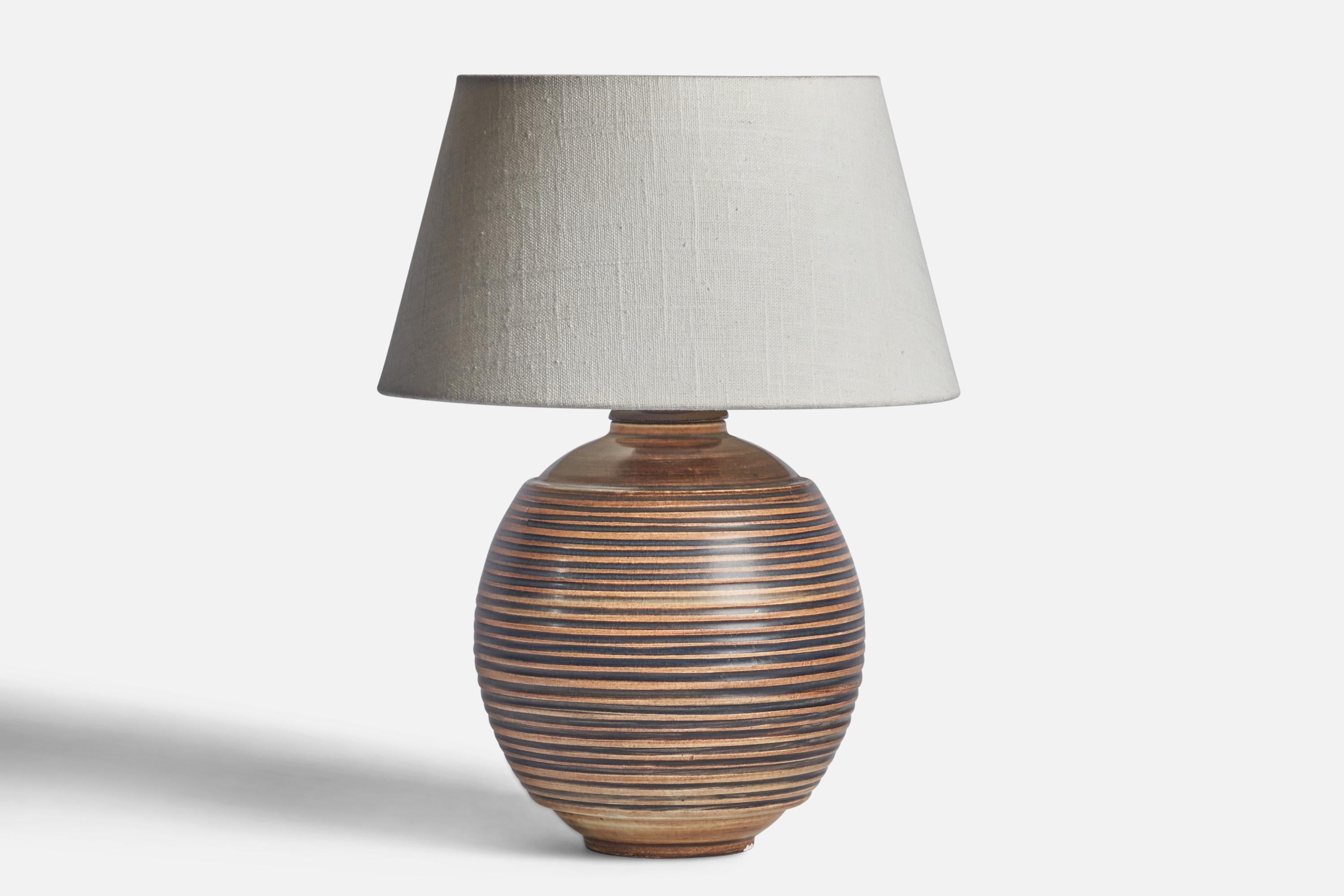 A brown-glazed incised stoneware table lamp designed by Gertrud Lönegren and produced by Rörstrand, Sweden, 1940s.

Dimensions of Lamp (inches): 10” H x 6.5” Diameter
Dimensions of Shade (inches): 7” Top Diameter x 10” Bottom Diameter x