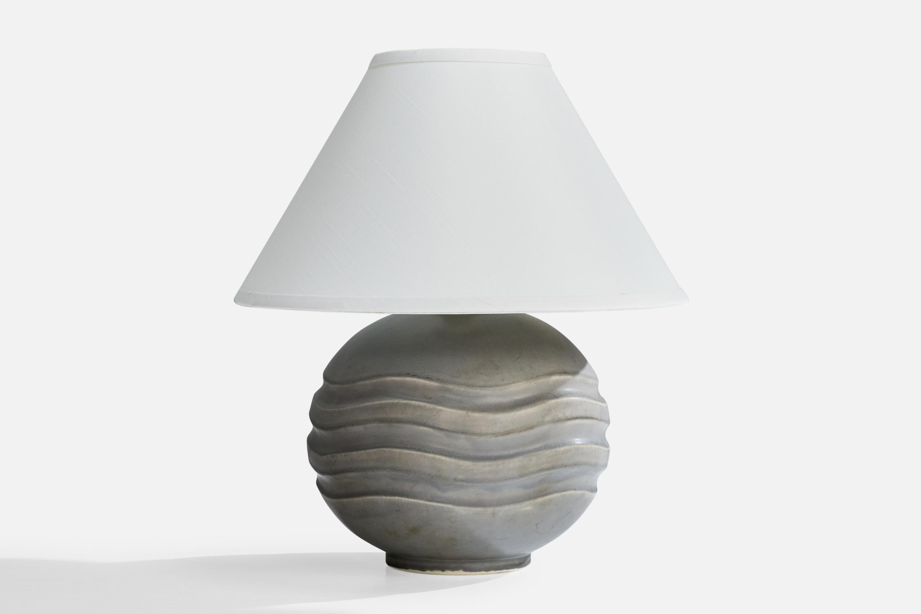 A grey-glazed stoneware table lamp designed by Gertrud Lönegren and produced by Rörstrand, Sweden, c. 1940s.

Dimensions of Shade (inches): 6” Top Diameter x 16” Bottom Diameter x 10” Height

Dimensions of Lamp with Shade (inches): 18.5” Height x