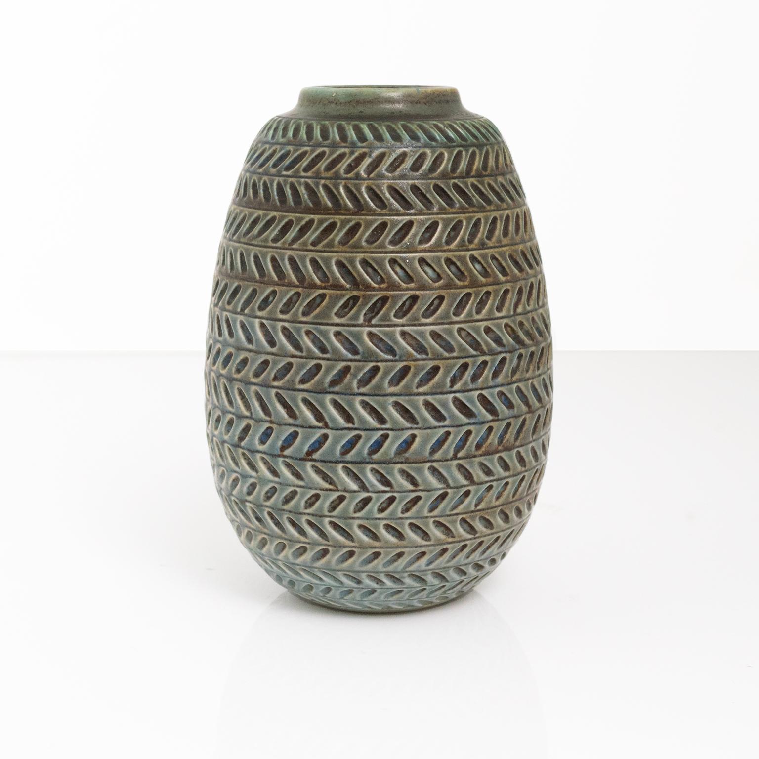 Gertrud Lonegren textured vase with bands of horizontal patterns in neutral blue and green. This studio piece was created at Rorstrand between 1937-42.
Measures: Height: 7