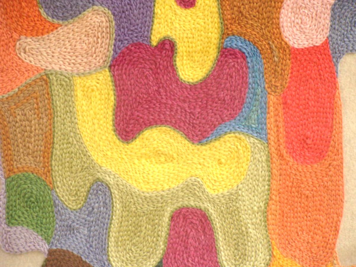Unique textile artwork by Gertrude Agranat. Framed under glass. Illustrated
and featured in the June 1961 issue of Interiors magazine. Crochet chain-stitch
appliqued to neutral woolen fabricin a colorful, abstract composition. Originally exhibited