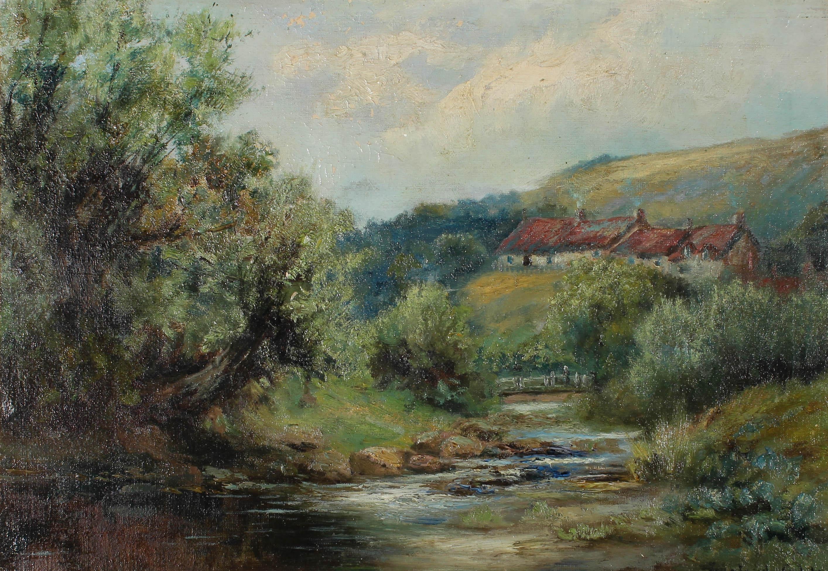 A charmingly rustic early 20th Century oil landscape showing a rural valley with a row of cottages nestled in the distant trees and a river running through the foreground. The artist has signed to the lower right (partially obscured by the frame).