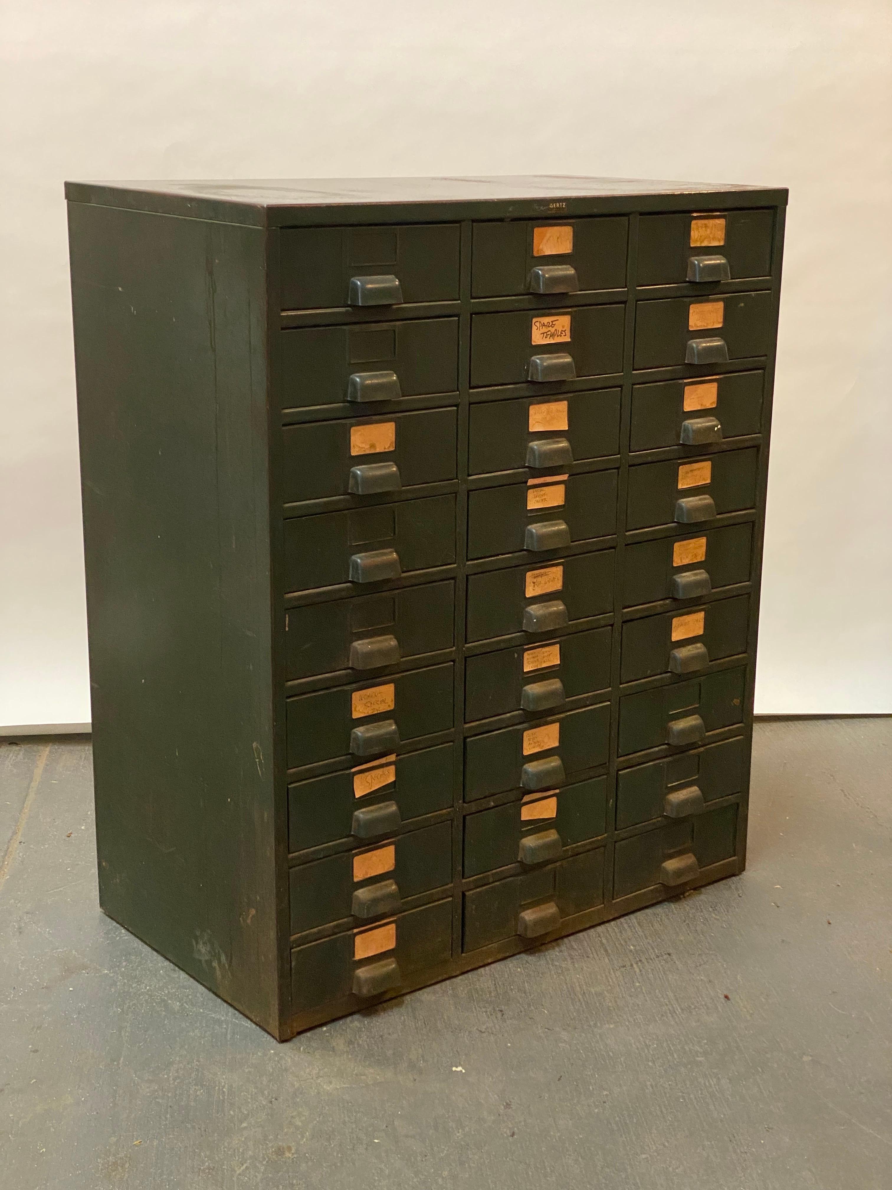 A nice example of older industrial or office cabinetry seen here in this 27 drawer steel cabinet. Signed and still retaining the original Gertz Jamaica decal. Gertz was a department store in Jamaica, Queens and most likely retailed by them in the
