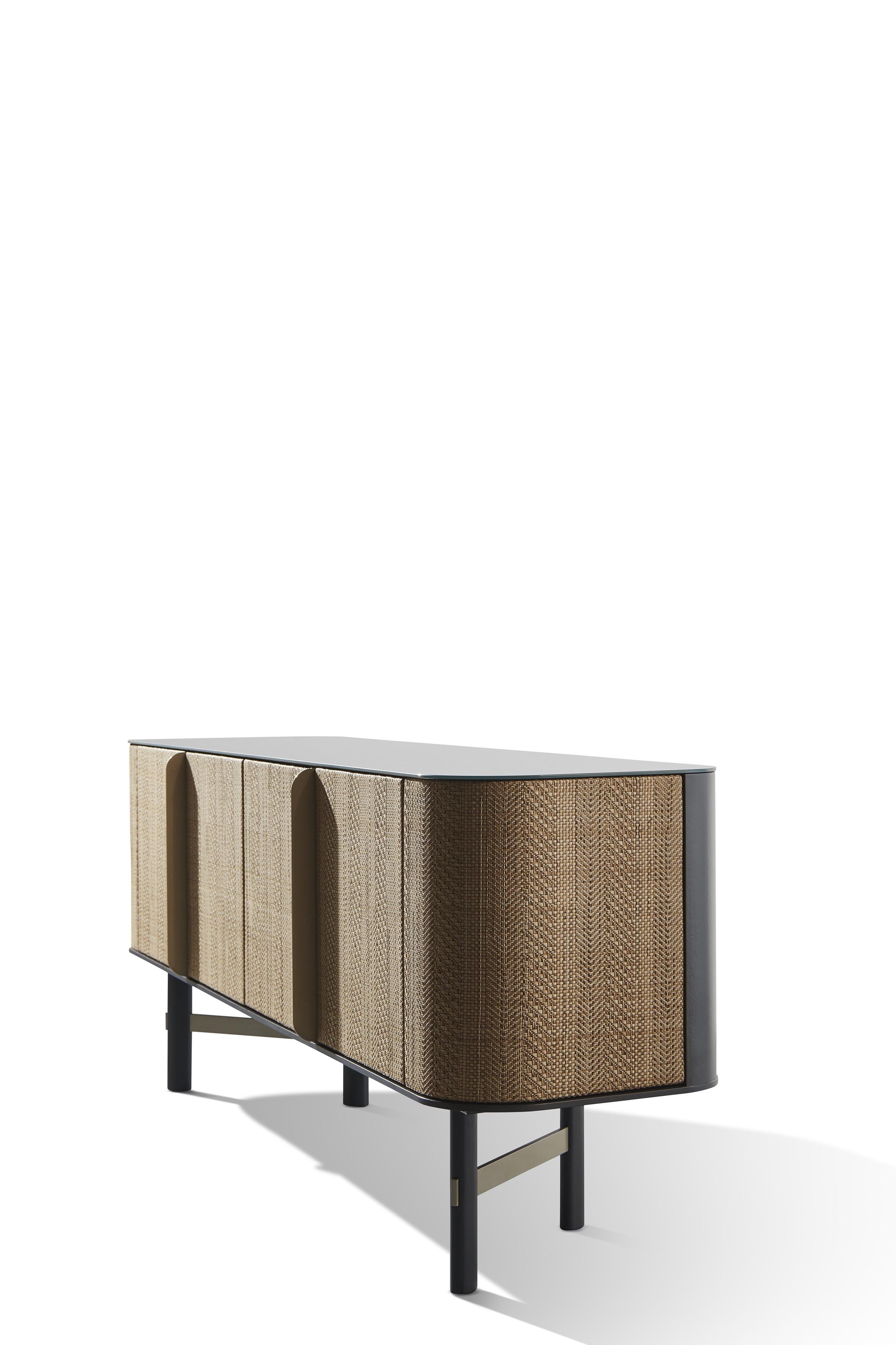 Sideboard with plywood and MDF lacquered body. Four doors upholstered in water-repellent and cleanable ecoleather One or two internal adjustable shelves. Top available in two options: 6 mm porcelain stoneware; 6 mm glass painted below.