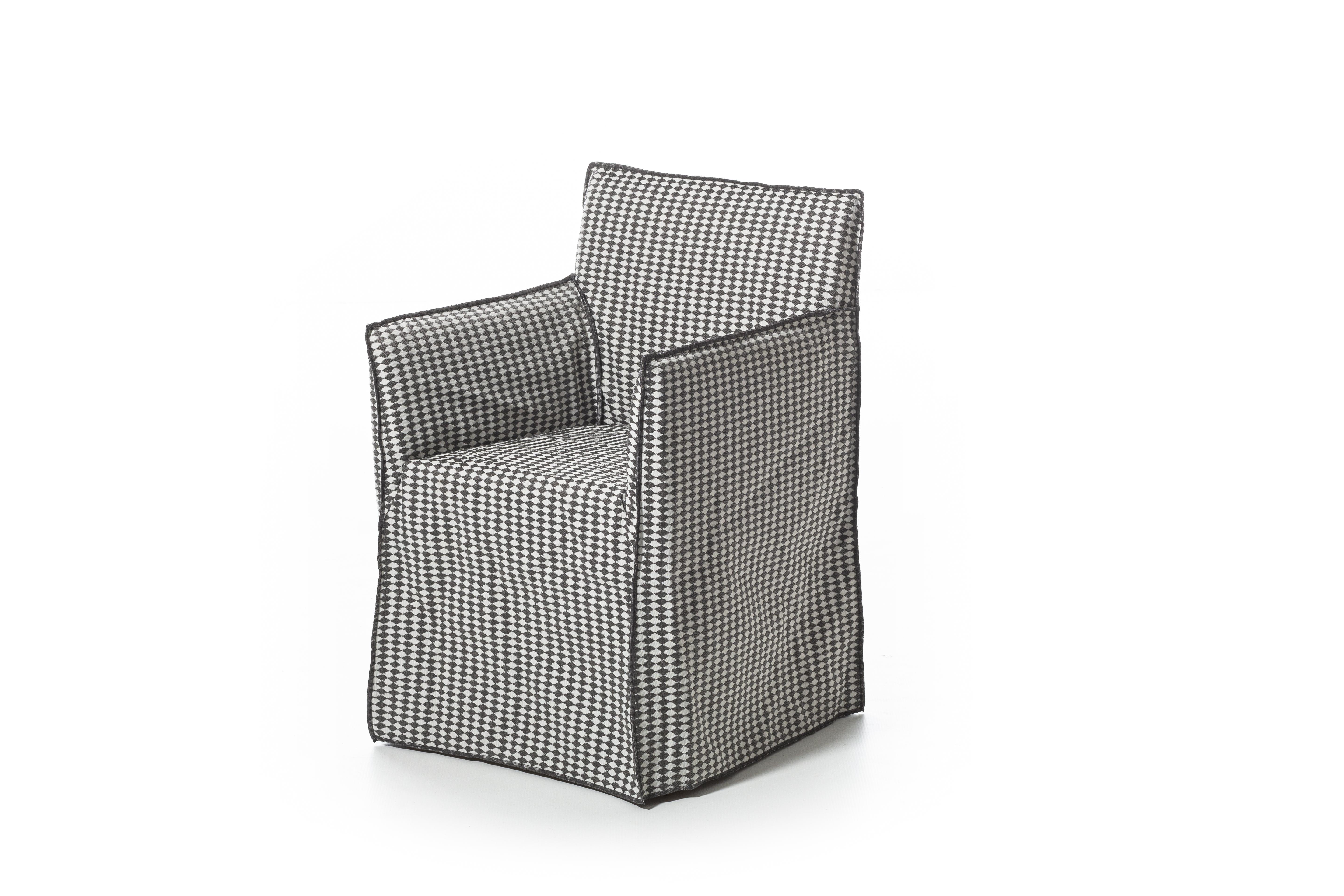 Family of padded chairs with removable upholstery, Ghost Out 23/25 boast a comfortable and enveloping seat, with or without armrests, that develops around a light shell with essential volumes. Designed to resist water and sunlight and to maintain
