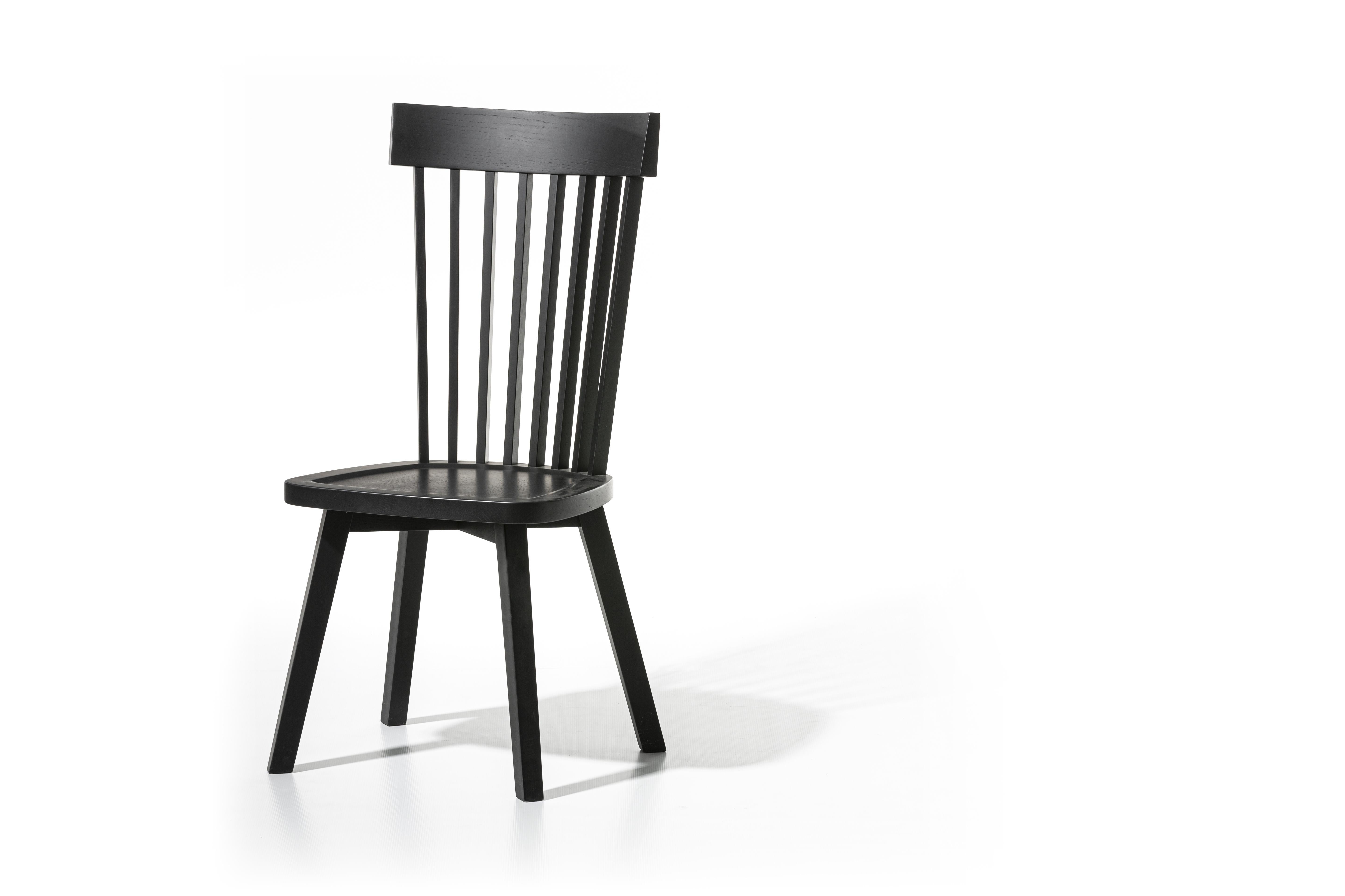 Single-material chair with high backrest and visible vertical slats without armrests, Gray 21 is characterised by clean and essential lines, with the structure in natural painted Canaletto walnut, bleached oak or white, grey, black, ocean or