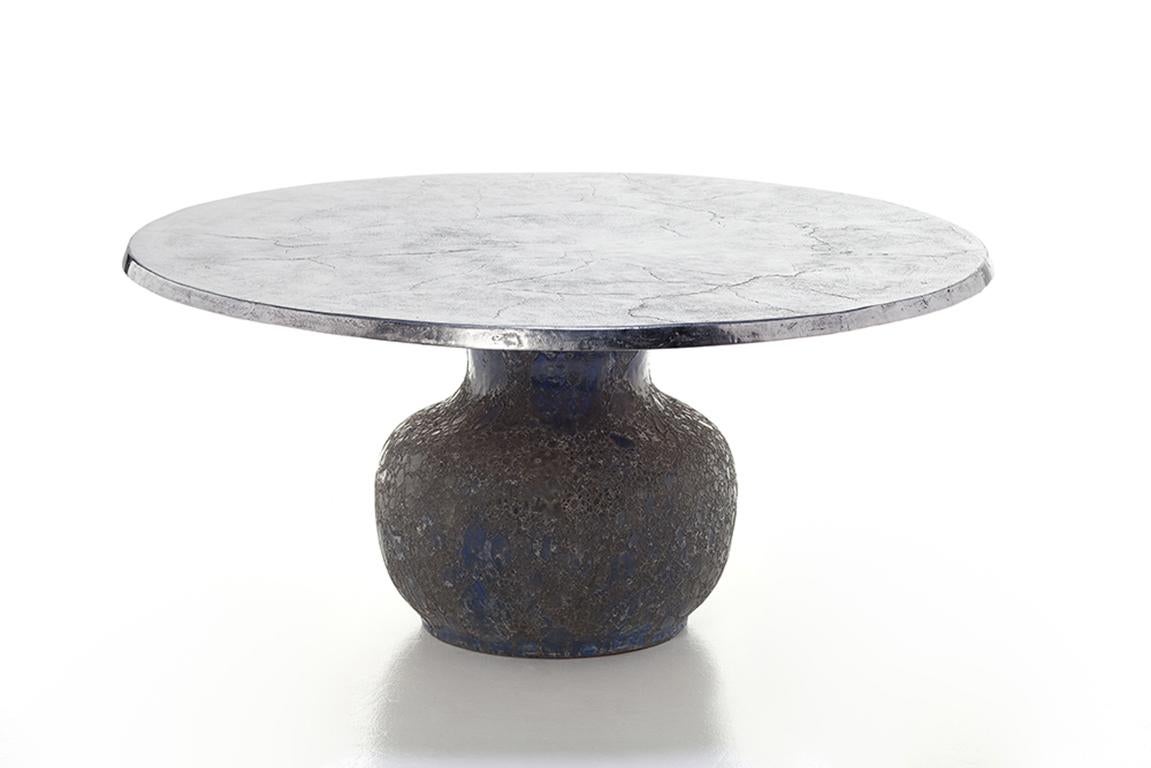 A bold combination of materials distinguishes the Moon 34-36 family of tables: the blue ceramic base in the shape of an amphora, characterised by an irregular material surface obtained with a particular hand finish, is combined with a round top,
