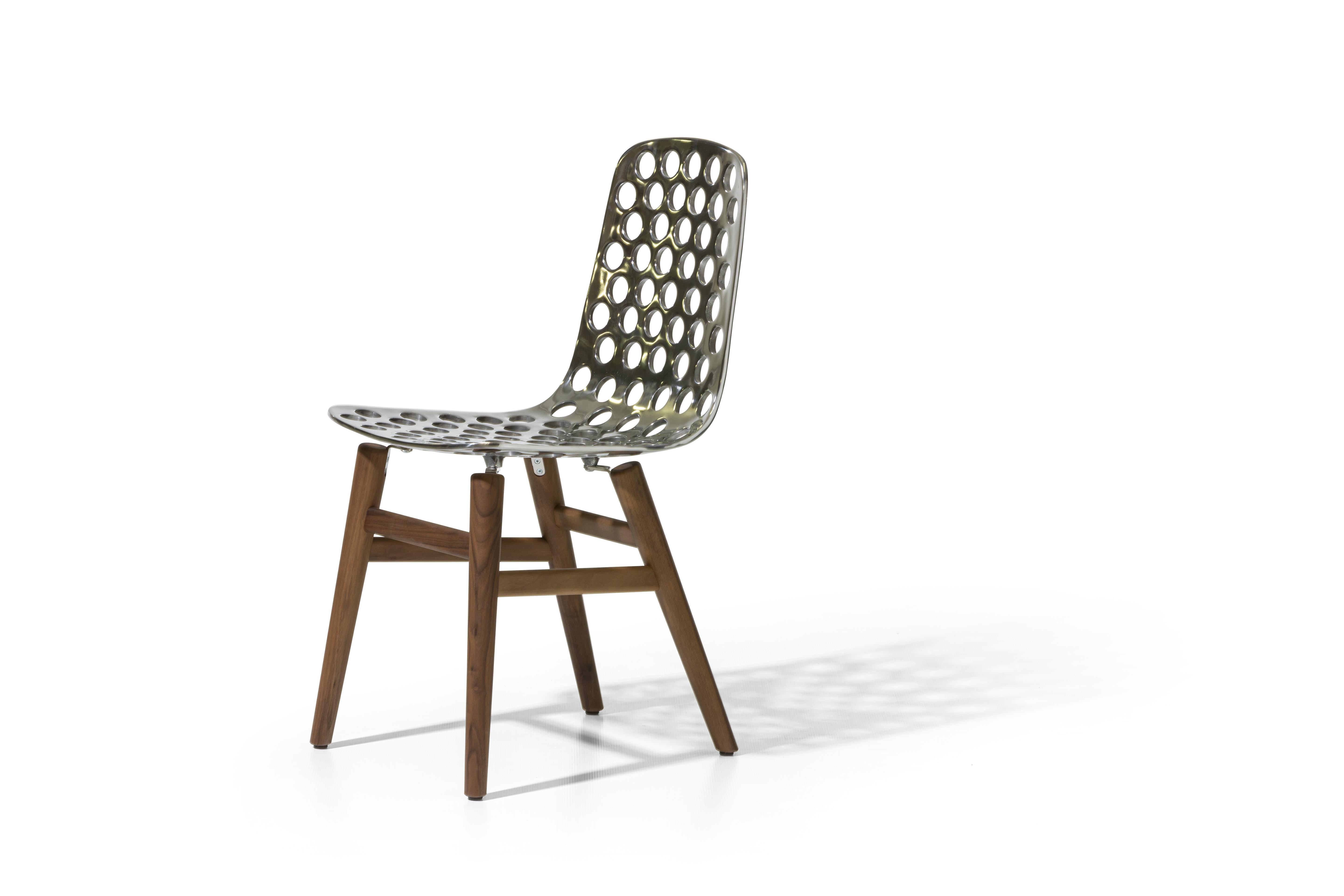 Gervasoni Next 121 shell cast polished aluminum chair in walnut by Paola Navone

Shell chair in cast polished aluminum decorated with macropores, wooden legs in walnut / oak. Available wood finishes: natural lacquered American walnut; bleached
