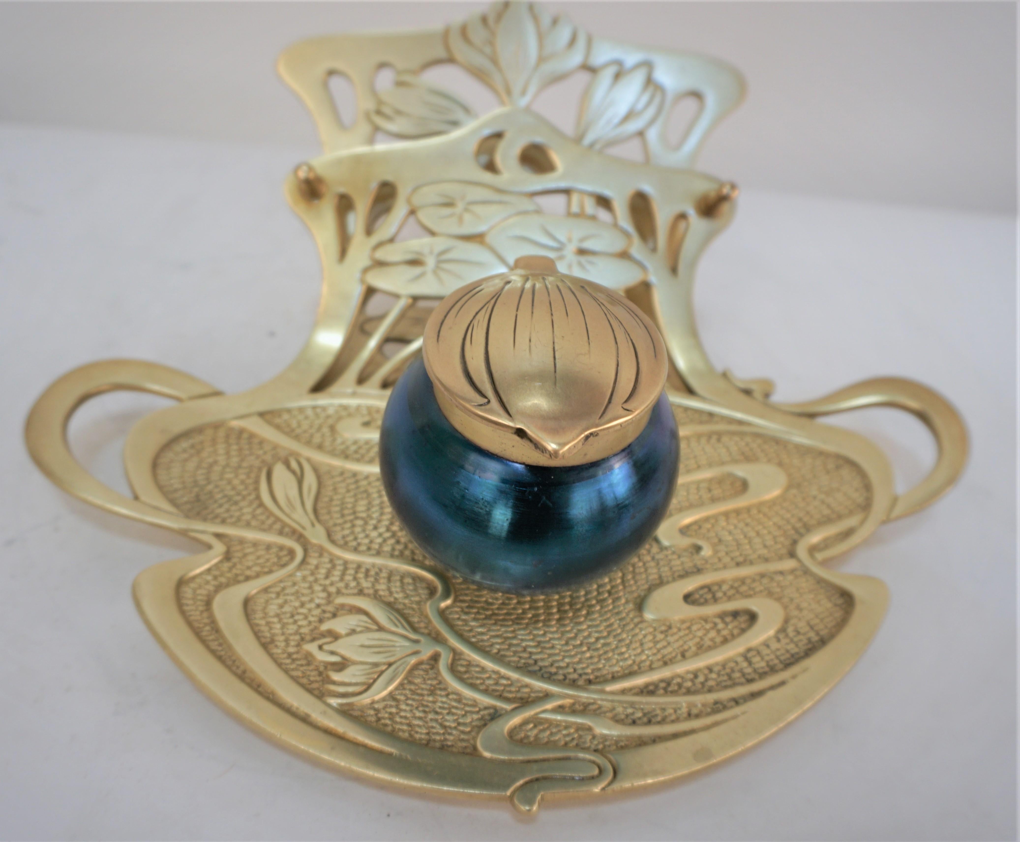 Geschutzt Austrian desk art glass inkwell. Crafted of fine quality Vienna bronze. Features blue color art glass inkwell with beautiful lily pattern design art nouveau bronze.