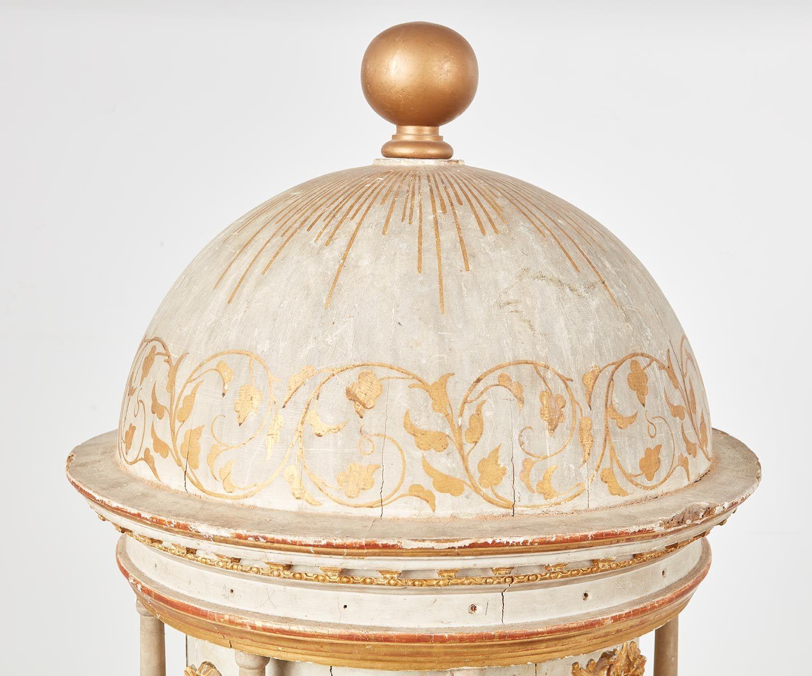 A splendid 18th c. Italian architectural model featuring a gessoed and gilt hemispherical dome on a circular entablature supported by a gessoed colonnaded facade with relief carved gilt acanthus swags and an arched door on a stepped plinth, with