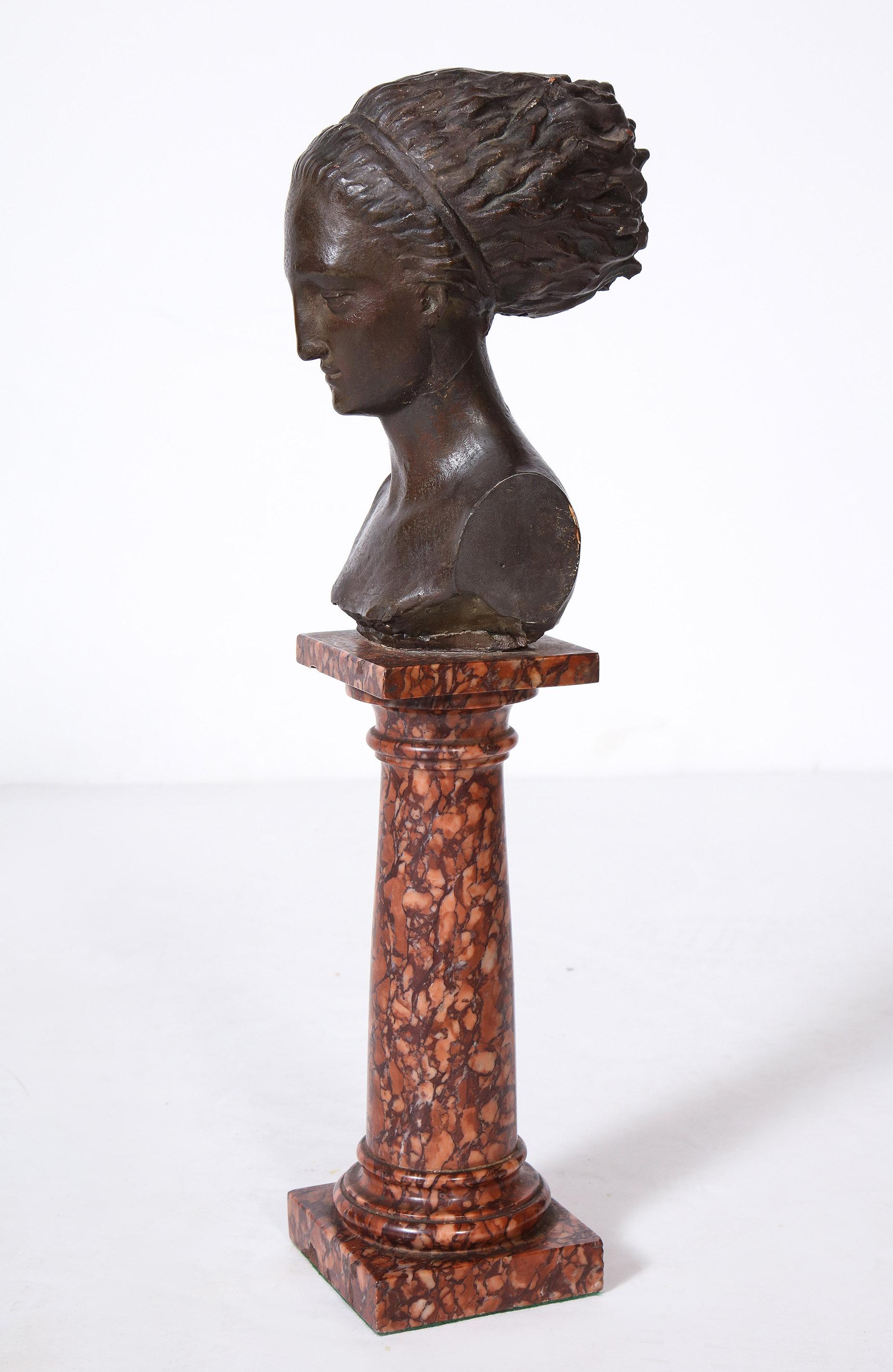 Cast Gesso Bust of a Classical Roman Woman

The cast gesso bust patinated to appear bronze mounted on a Rosso Brocatelle column form base.