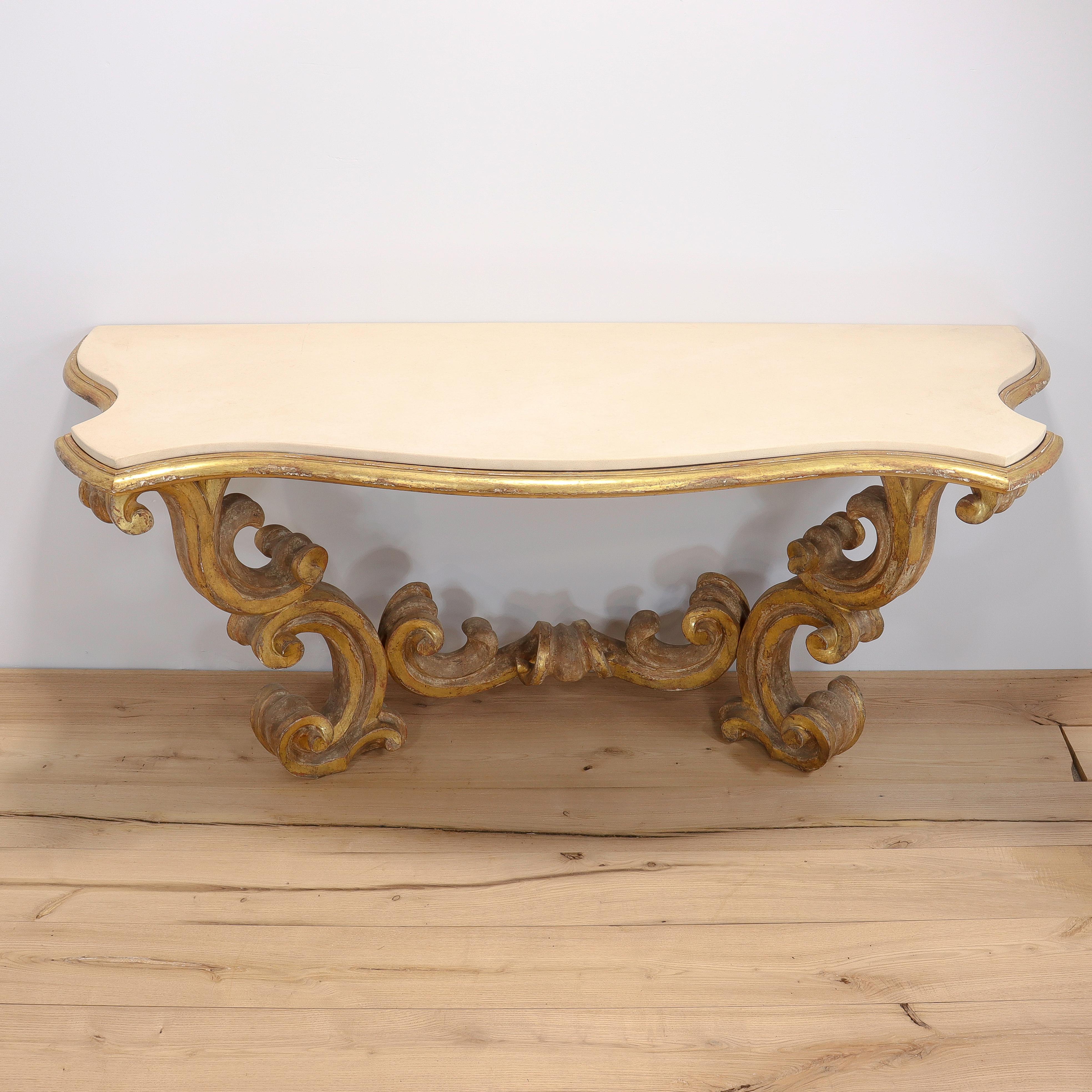 A fine custom made Louis XV or Rococo style table.

With a gessoed and gilt wooden base in the high Rococo style with carved 