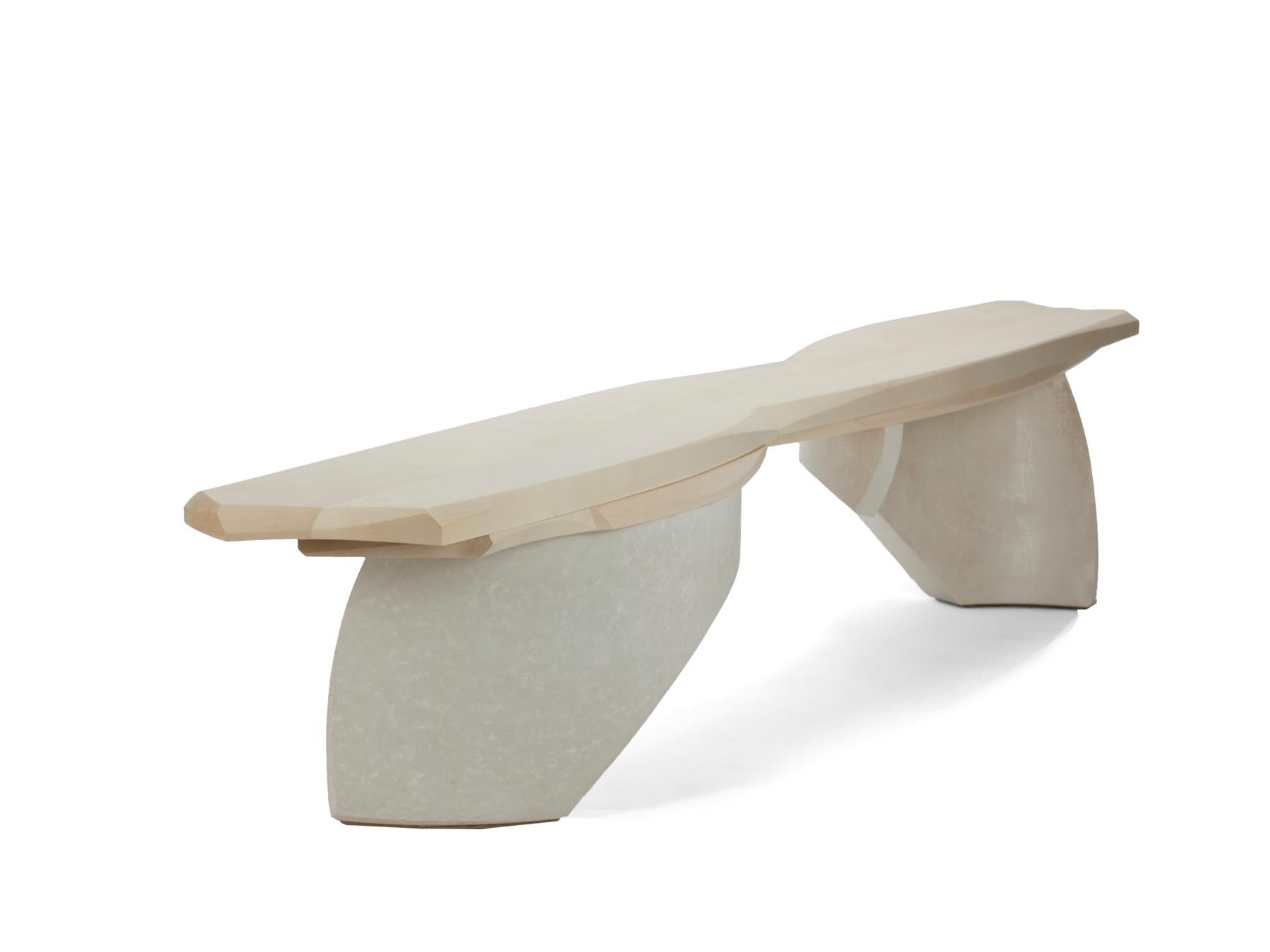 The waves bench is comprised of two curved cast concrete legs which establish the dynamic movement of the piece. The bleached maple seat is layered in reaction to that movement. The hourglass shape of the seat further enhances the movement that