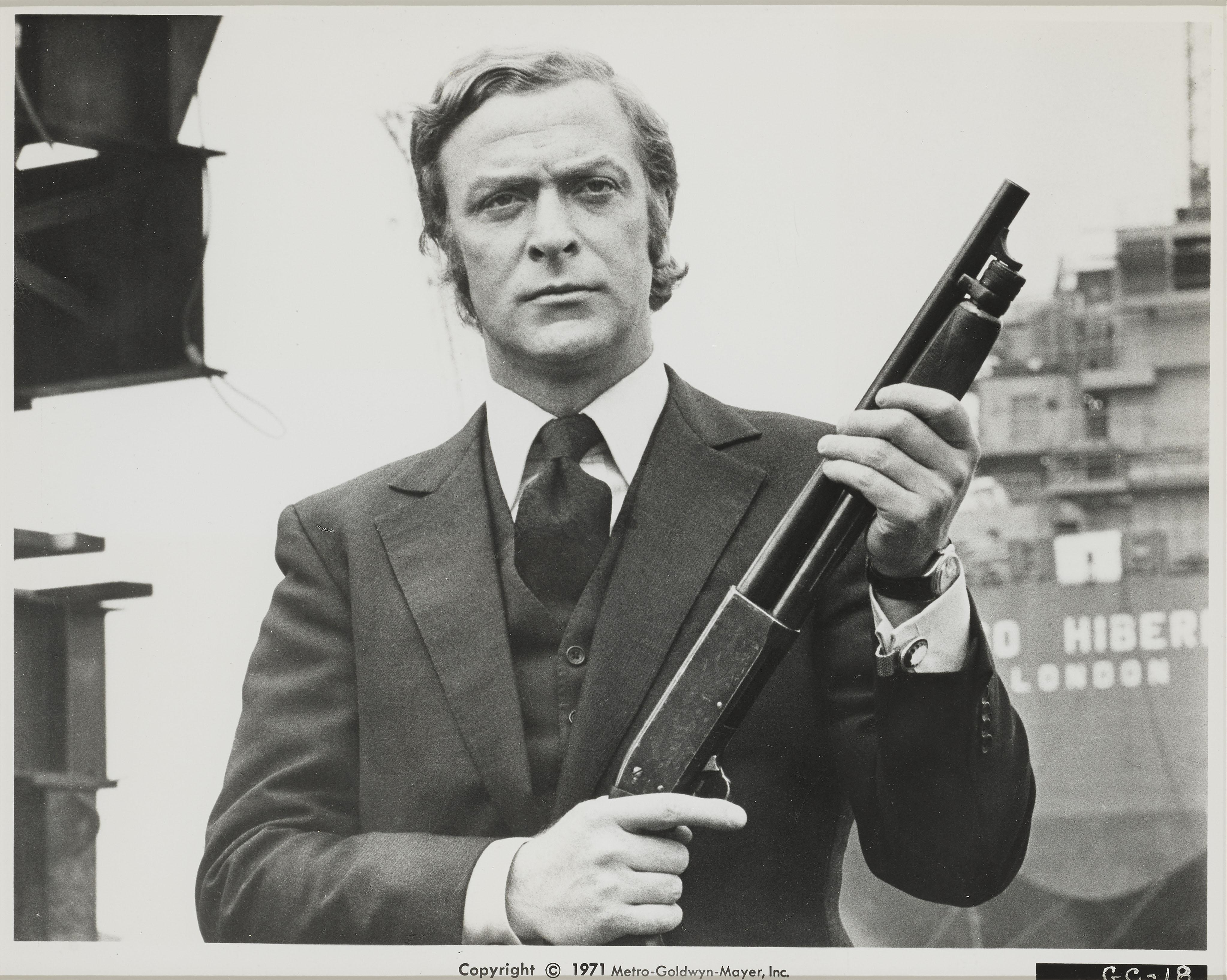 Original US production still for Michael Caine's Classic, 1971 gangster thriller.
Directed by Mike Hodges. This is one of the best images from the film. 
The piece is conservation framed with UV plexiglass in a Tulip wood frame with acid free card