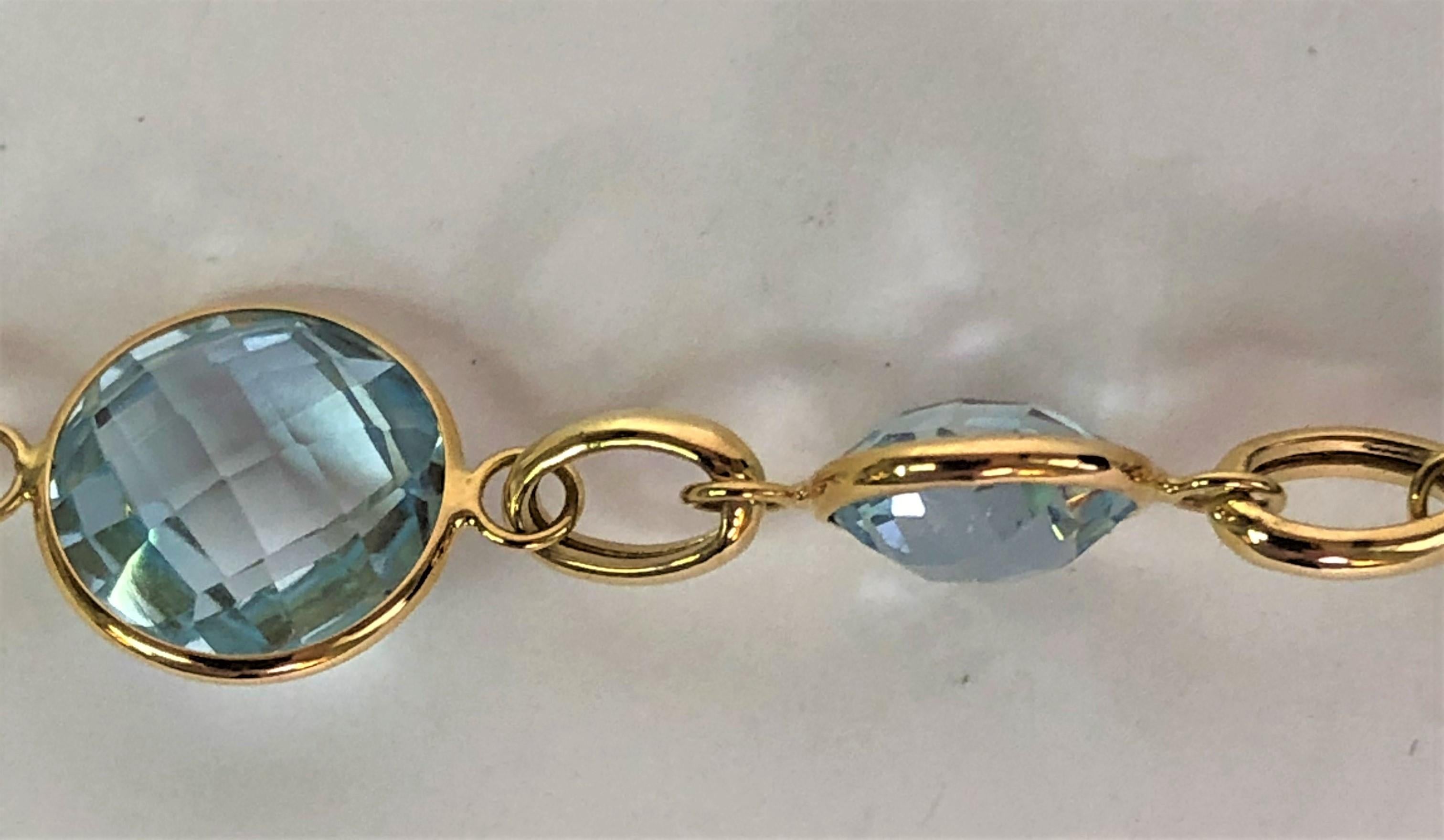 Getana & Co. designer
14 karat yellow gold
8 round checkerboard round cut blue topaz stones connected by oval links
Stones range from 5mm to 8mm round
Approximately 7.5 inches long, adjustable to 6.5 inches
Stamped 