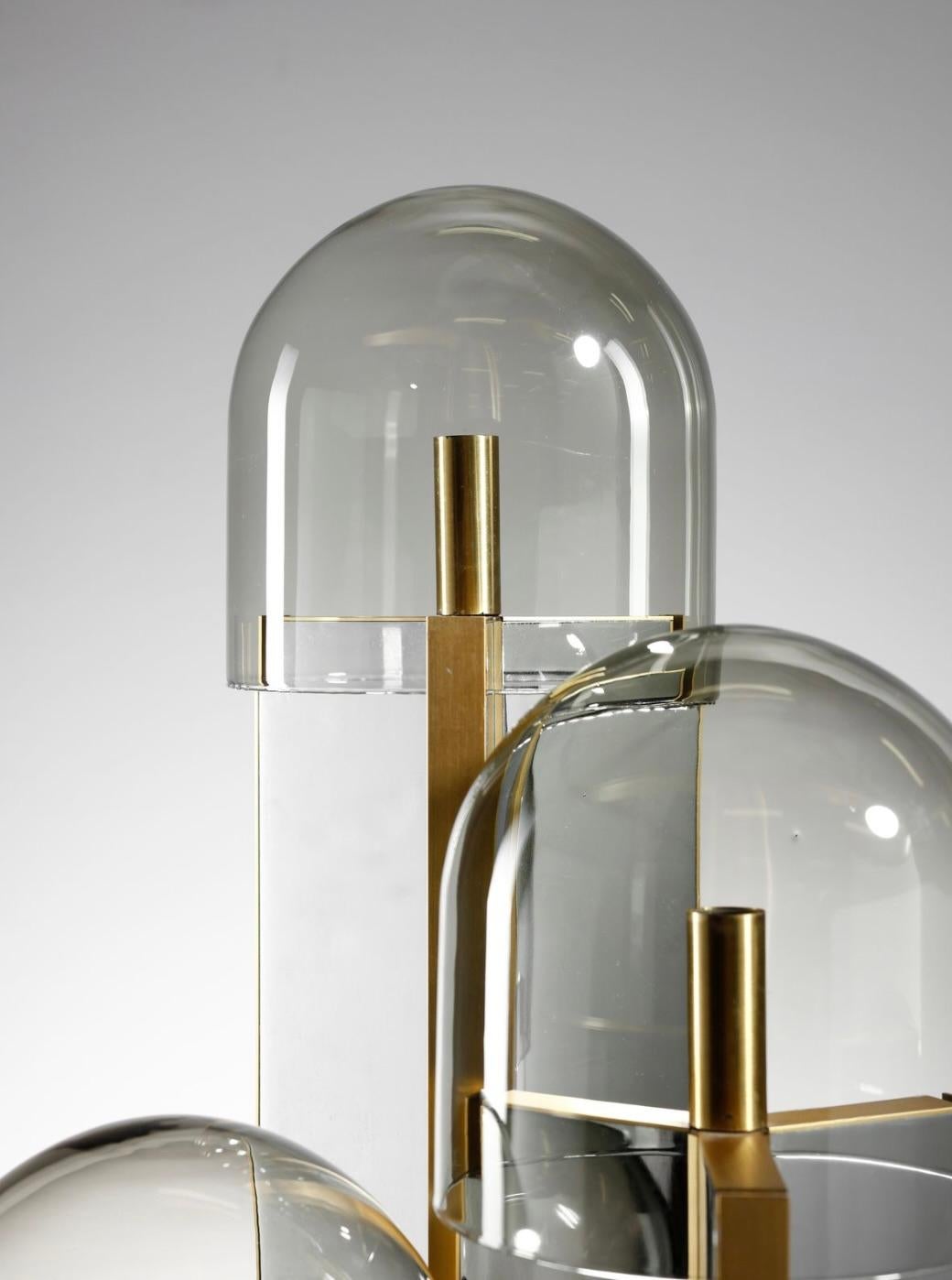A very rare Getano Sciolari (1927 - 1994)  table lamp constructed of mirrored metal, brass-plated metal each of the three columns topped with a hand blown smoked glass dome, circa 1970
Paper label to underside. 

